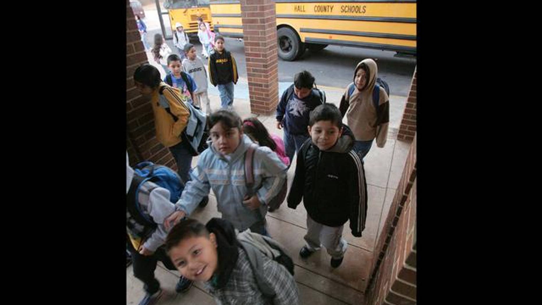 ** ADVANCE FOR WEEKEND OF MARCH 19-20 **Students make their from their buses to school at the Lyman Hall Elementary school in Gainesville, Ga., Wednesday, Feb. 23, 2005. Lyman Hall Elementary is listed as 94 percent Hispanic. (AP Photo/Ric Feld)