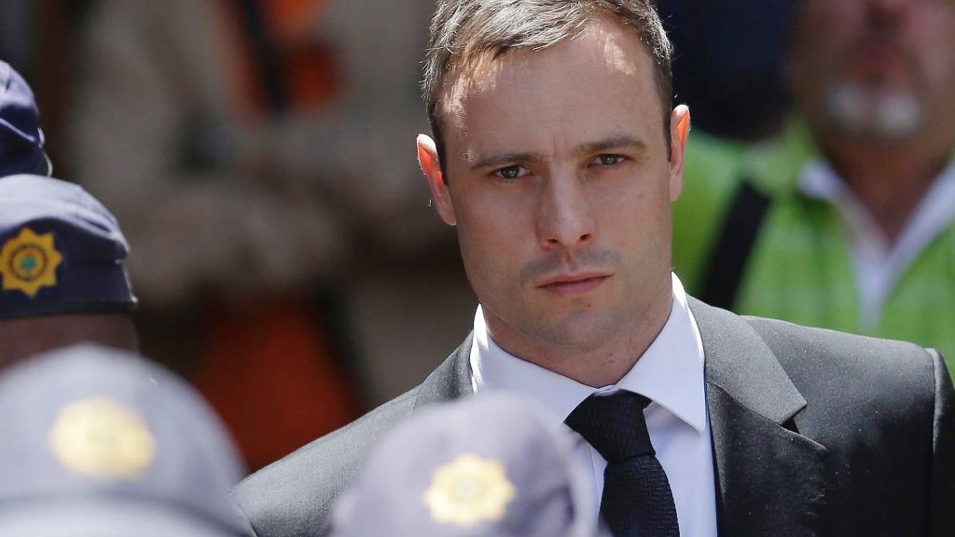 FILE - In this Friday, Oct. 17, 2014 file photo, Oscar Pistorius is escorted by police officers as he leaves the high court in Pretoria, South Africa. Pistorius' lawyers say prosecutors are persisting with a "failed case" by appealing the double-amputee athlete's acquittal for murder at South Africa's Supreme Court. Pistorius' lawyers made the argument in papers filed Wednesday, Sept. 16, 2015 to the Supreme Court, meeting Thursday's deadline to respond. (AP Photo/Themba Hadebe, File)
