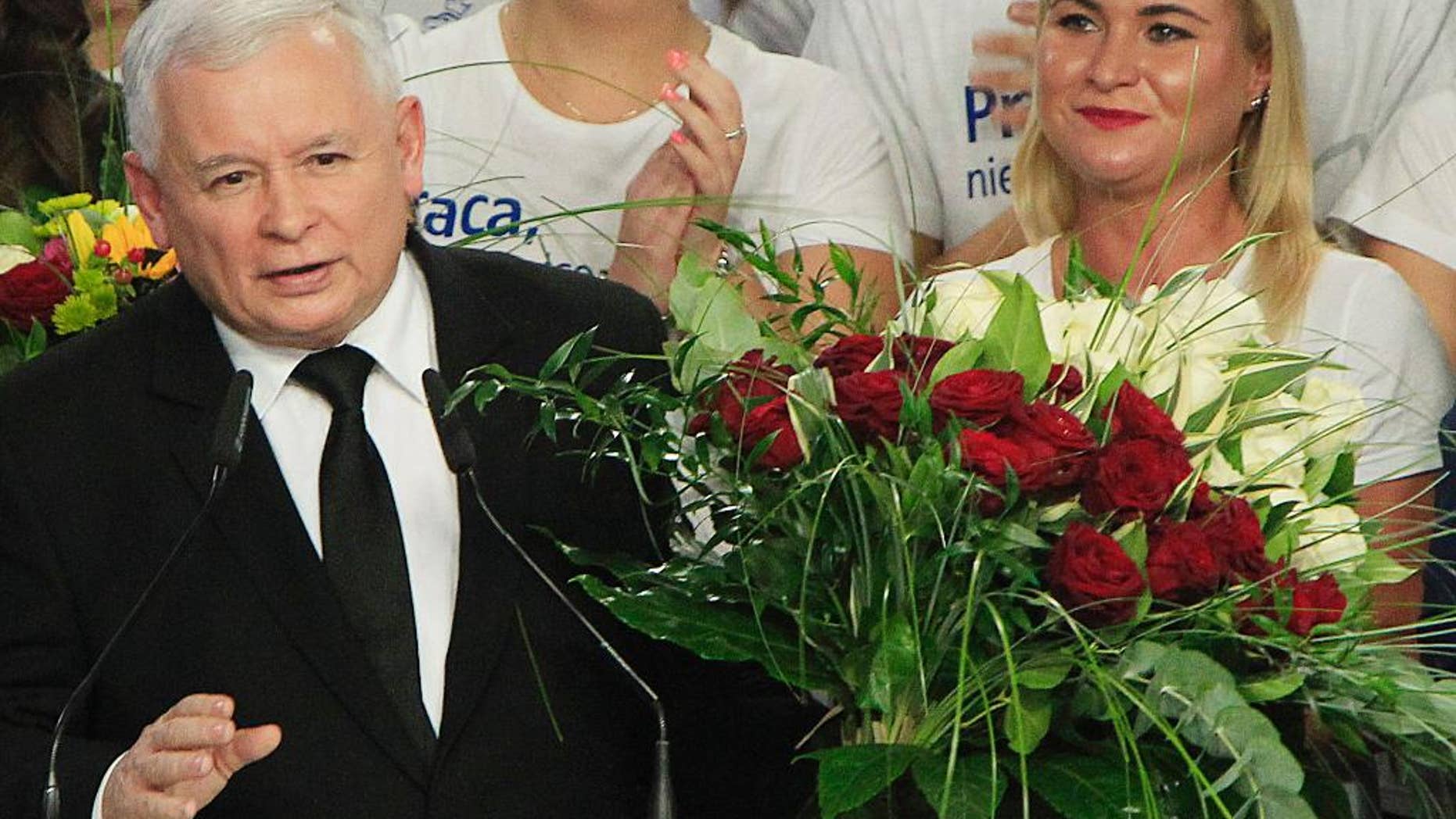 Jaroslaw Kaczynski, left, leader of the conservative opposition Law and Justice party announces victory in the general elections in Poland at the party's headquarters in Warsaw, Poland, on Sunday, Oct.25, 2015. The victory of his Eurosceptic party ends eight years in power of pro-EU, pro-business Civic Platform which voters accuse of being conformist, detached and focused on power rather than on improving the living in Poland.(AP Photo/Czarek Sokolowski)