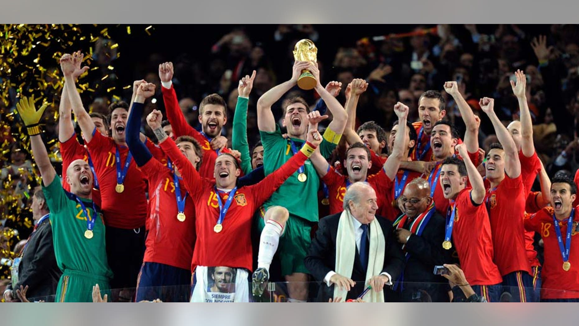 Spain goalkeeper Iker Casillas holds up the trophy after the World Cup final soccer match between the Netherlands and Spain at Soccer City in Johannesburg, South Africa, Sunday, July 11, 2010. Spain won 1-0. (AP Photo/Martin Meissner)