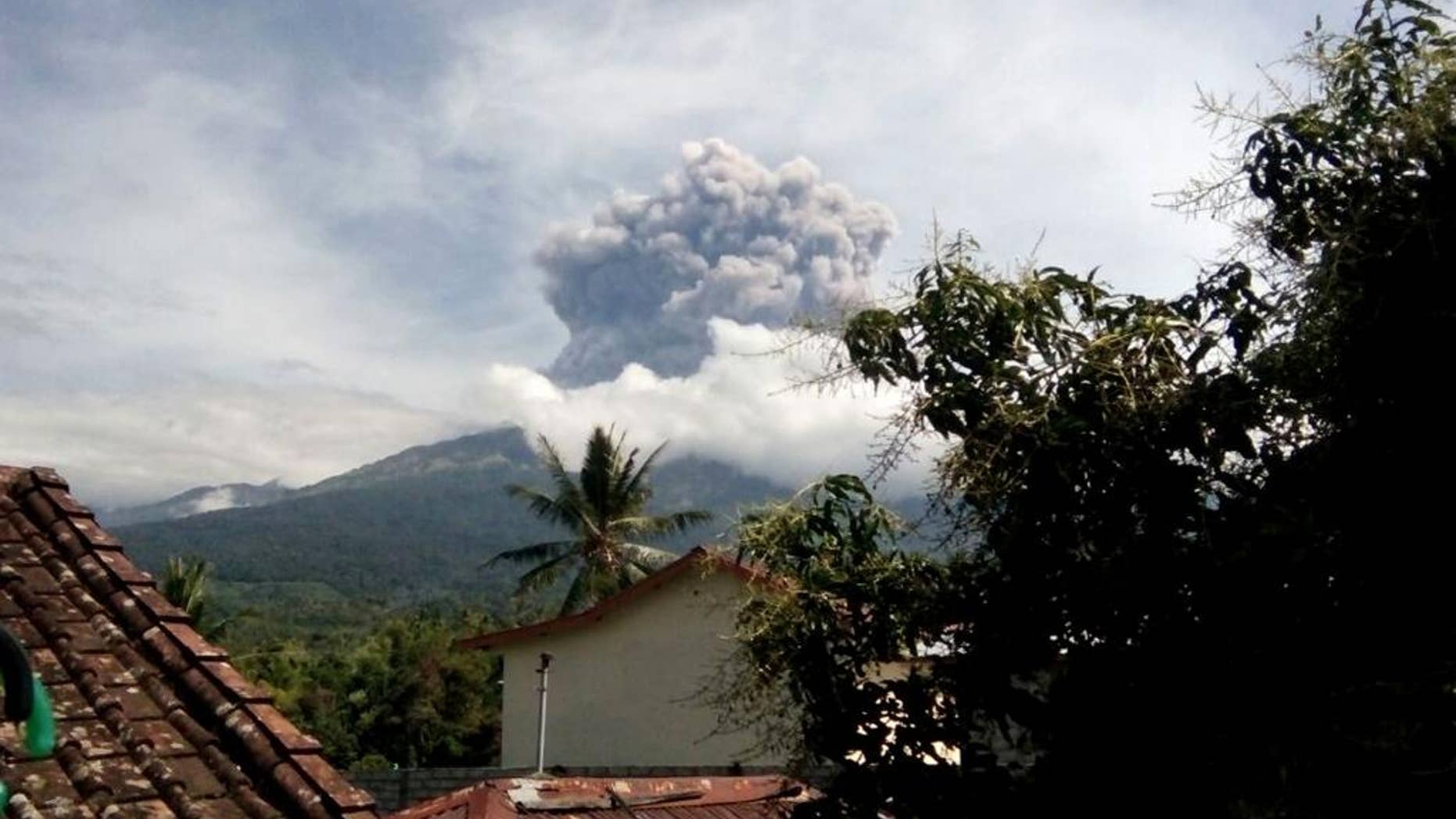 In this Tuesday, Sept. 27, 2016 photo, volcanic material from the eruption of Mount Barujari is seen from Bayan, Lombok Island, Indonesia. The volcano erupted without warning on Tuesday afternoon, delaying flights from airports on the islands of Lombok and Bali. (AP Photo/Denda Wiyana Putri)