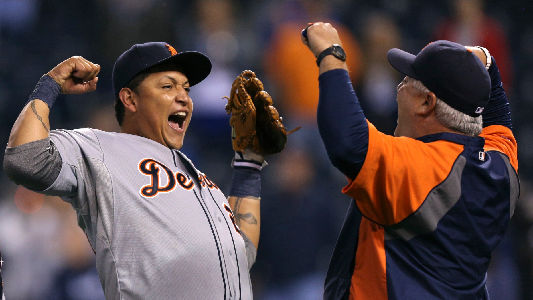 KANSAS CITY, MO - OCTOBER 1: Miguel Cabrera #24 of the Detroit Tigers and bullpen coach Mike Rojas celebrate after winning the American League Central title at Kauffman Stadium on October 1, 2012 in Kansas City, Missouri. (Photo by Ed Zurga/Getty Images)