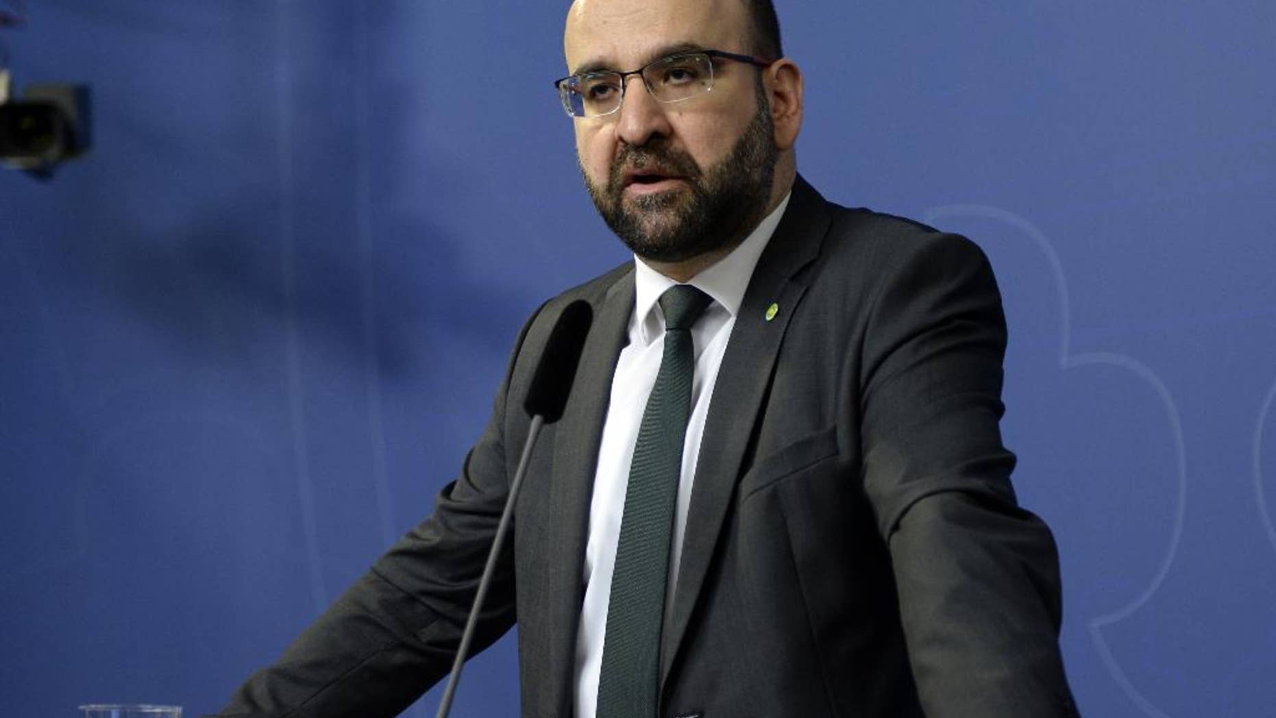 FILE - In this April 18, 2016 file photo, Sweden's Housing Minister Mehmet Kaplan appears before the media to confirm his resignation in Stockholm, Sweden. One refused to shake hands with a female journalist. Another compared Israel to Nazi Germany. A third was seen doing hand signs associated with Egypt’s Muslim Brotherhood in the background of a live TV broadcast. The behavior of some Muslim members of Sweden’s Green Party, which is part of a coalition government since 2014, has sparked concerns that the small environmentalist group may have been infiltrated by Islamists. It also has triggered a wider discussion about whether Sweden has tried so hard to be inclusive and tolerant toward migrants that it's failed to stand up for its own feminist ideals.(Jessica Gow / TT via AP, File) SWEDEN OUT