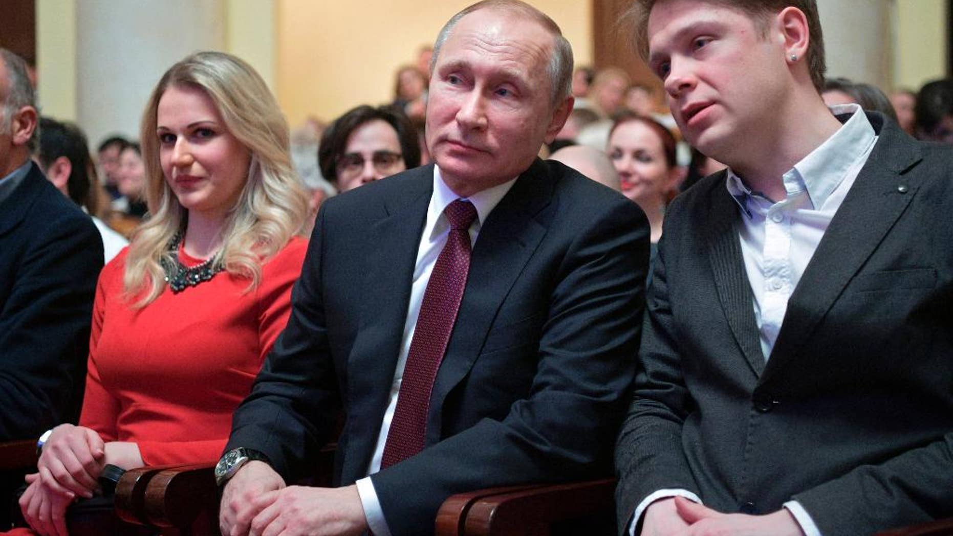 Russian President Vladimir Putin, center, attends a concert opening the 10th Winter International Arts Festival in the Black Sea resort of Sochi, Russia, Friday, Feb. 17, 2017. At right is singer of the Mariinsky Theatre, Yevgeny Chernyadyev. At left is opera singer Dara Savinova. (Alexei Druzhinin/Pool Photo via AP)