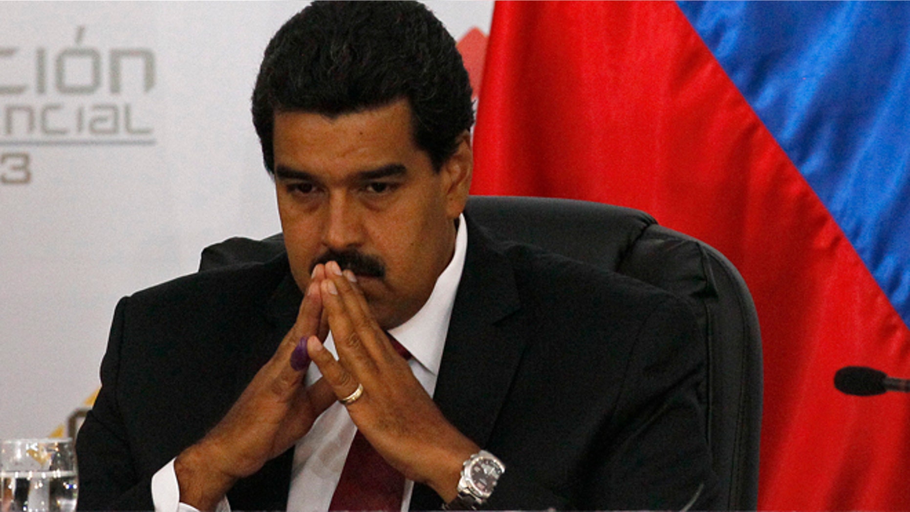 Venezuela's then-interim President Nicolas Maduro sits as he waits for the official ceremony at the Electoral Council to certify his presidential election victory in Caracas, Venezuela, Monday, April 15, 2013. Sunday's elections in Venezuela have Maduro opponents calling his victory a sham.
