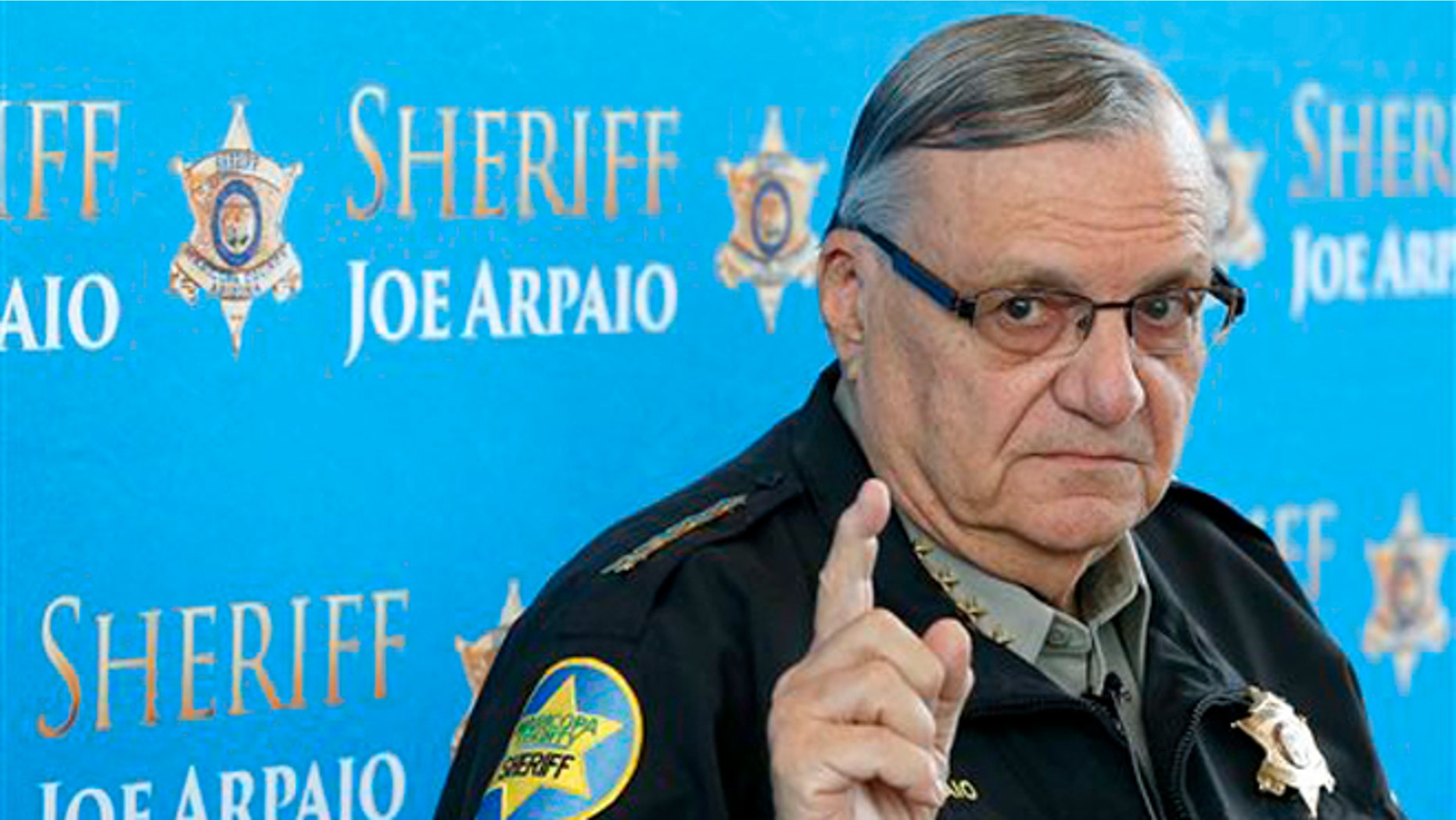 FILE - In this Dec. 18, 2013 file photo, Maricopa County Sheriff Joe Arpaio pauses as he answers a question at a news conference at Maricopa County Sheriff's Office Headquarters, in Phoenix. A judge presiding over a racial profiling case against Arpaioâs office is holding a hearing Wednesday, May 7, 2014, to examine whether people working for the agency have read a summary of the caseâs key findings. (AP Photo/Ross D. Franklin, file)