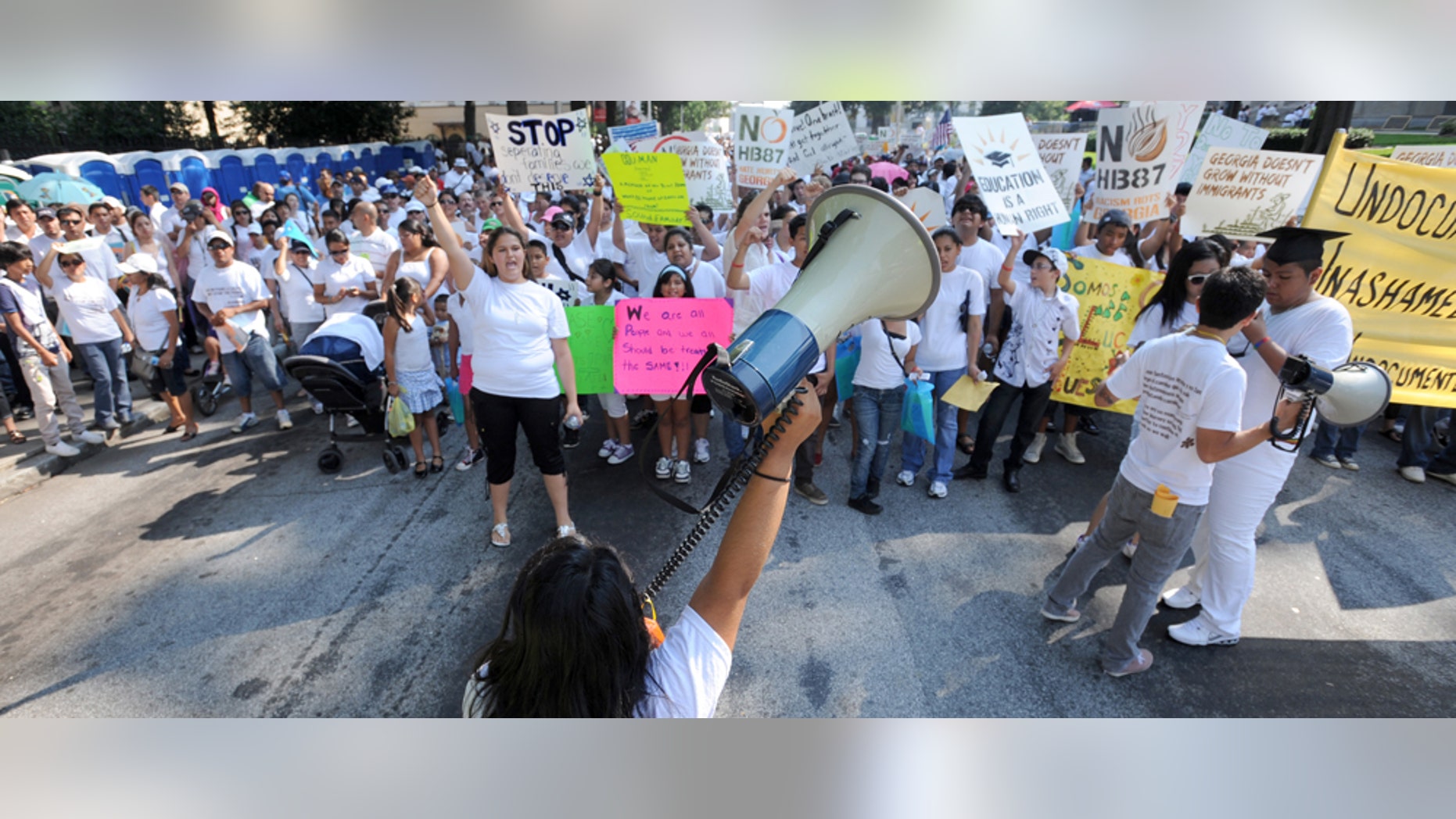 July 2: Thousands of people march through downtown Atlanta in protest against Georgia's strict new immigration law in Atlanta. (AP Photo/Erik S. Lesser)