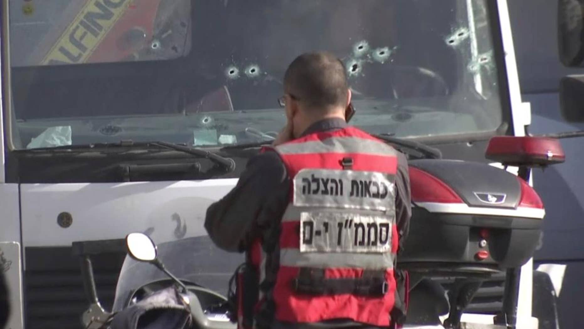 This frame grab from video, shows an Israeli emergency services personnel at scene of a truck-ramming attack in Jerusalem that killed at least four people and wounded several others in Jerusalem, Sunday, Jan. 8, 2017. Israeli police and rescue services said a Palestinian rammed his truck into a group of Israeli soldiers in one of the deadliest attacks of a more than yearlong campaign of violence. Security camera footage shows the truck barreling at a high speed off the road and into the crowd of people in the Armon Hanatziv neighborhood. (AP Photo)
