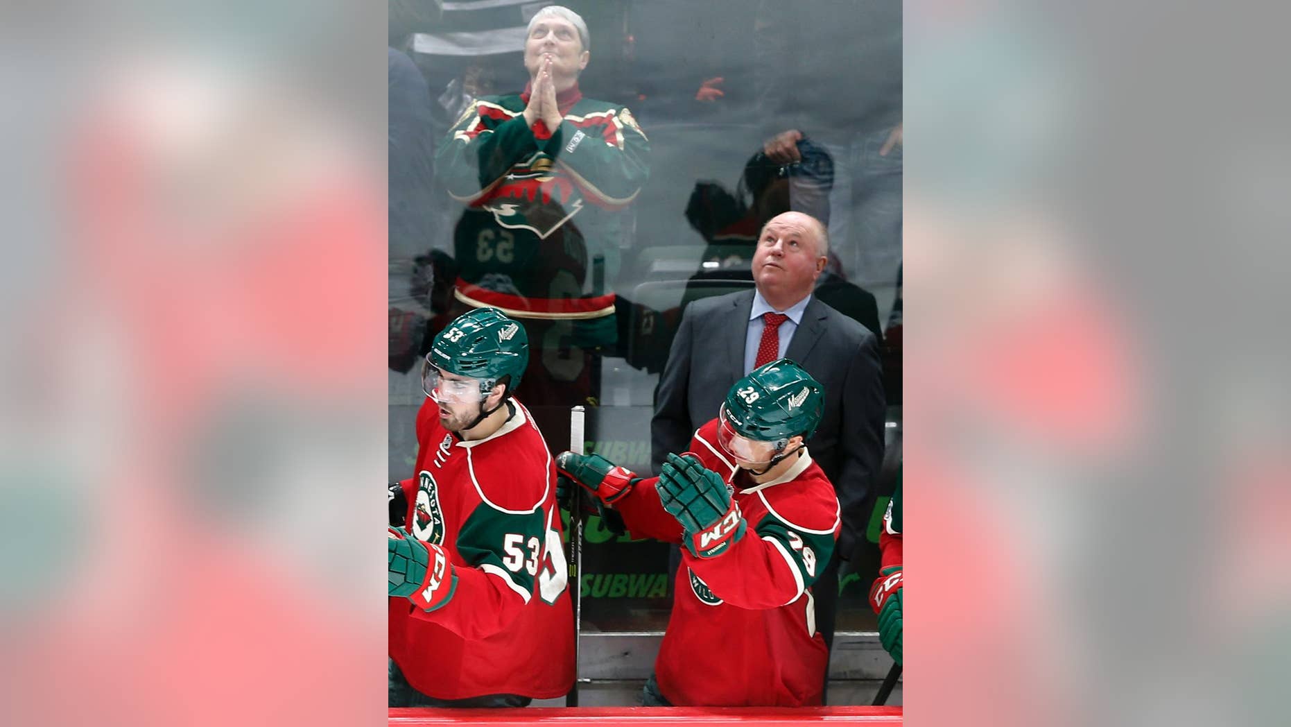 FILE - In this Feb. 18, 2017, file photo, Minnesota Wild head coach Bruce Boudreau watches the replay of a goal by Minnesota Wild's Mikko Koivu, of Finland, during the third period of an NHL hockey game in St. Paul, Minn. Boudreau is back in the playoffs with a third team, the Minnesota Wild in his debut season. For the eighth time in this unique character of a coach's nine postseason appearances, his team has one of the top two records in its conference. But that 1-7 career Game 7 record can't be ignored. (AP Photo/Jim Mone, File)