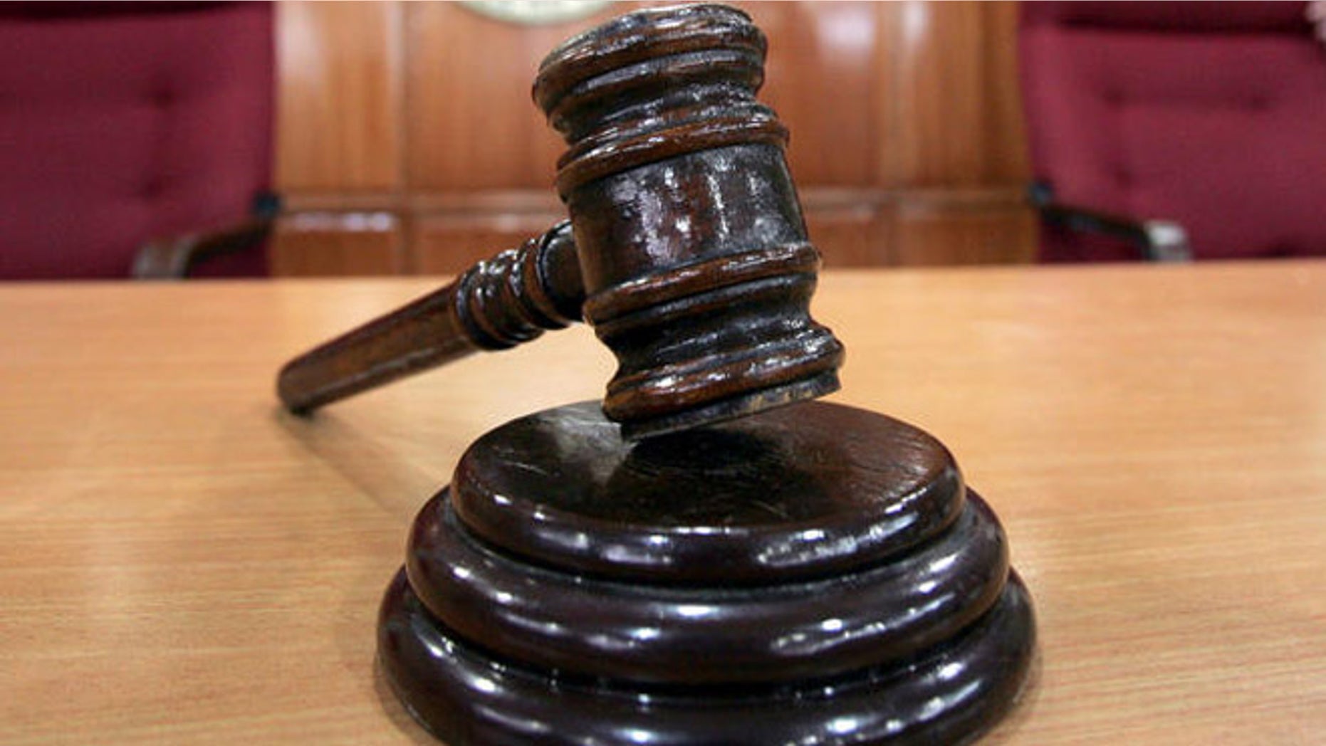 A Sandiganbayan anti-graft court sheriff adjusts chairs inside a courtroom in Quezon city northeast of Manila, Philippines, Tuesday Sept. 11, 2007, where a verdict in ousted Philippine President Joseph Estrada's corruption trial will be announced on Wednesday. (AP Photo/Bullit Marquez)