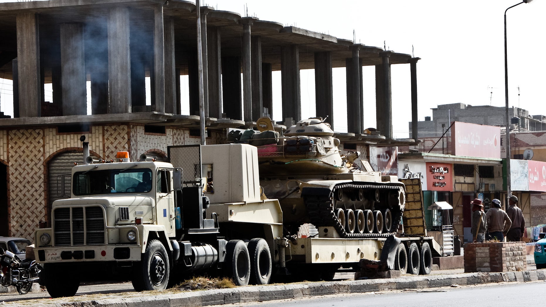 An Egyptian Army vehicle with a tank heads to the closed Rafah border crossing between Egypt and the Gaza strip, in Sheikh Zuweyid, northern Sinai, Egypt, Monday, May 20, 2013. Security officials said 17 military and more than 20 police armored vehicles were deployed in northern Sinai Monday as a response to the kidnapping by suspected militants of six policemen and a border guard there last Thursday. It was not clear if they deployed to rescue the hostages, to make a show of force to intimidate their captors, or for another reason. (AP Photo/Roger Anis, El Shorouk Newspaper) EGYPT OUT