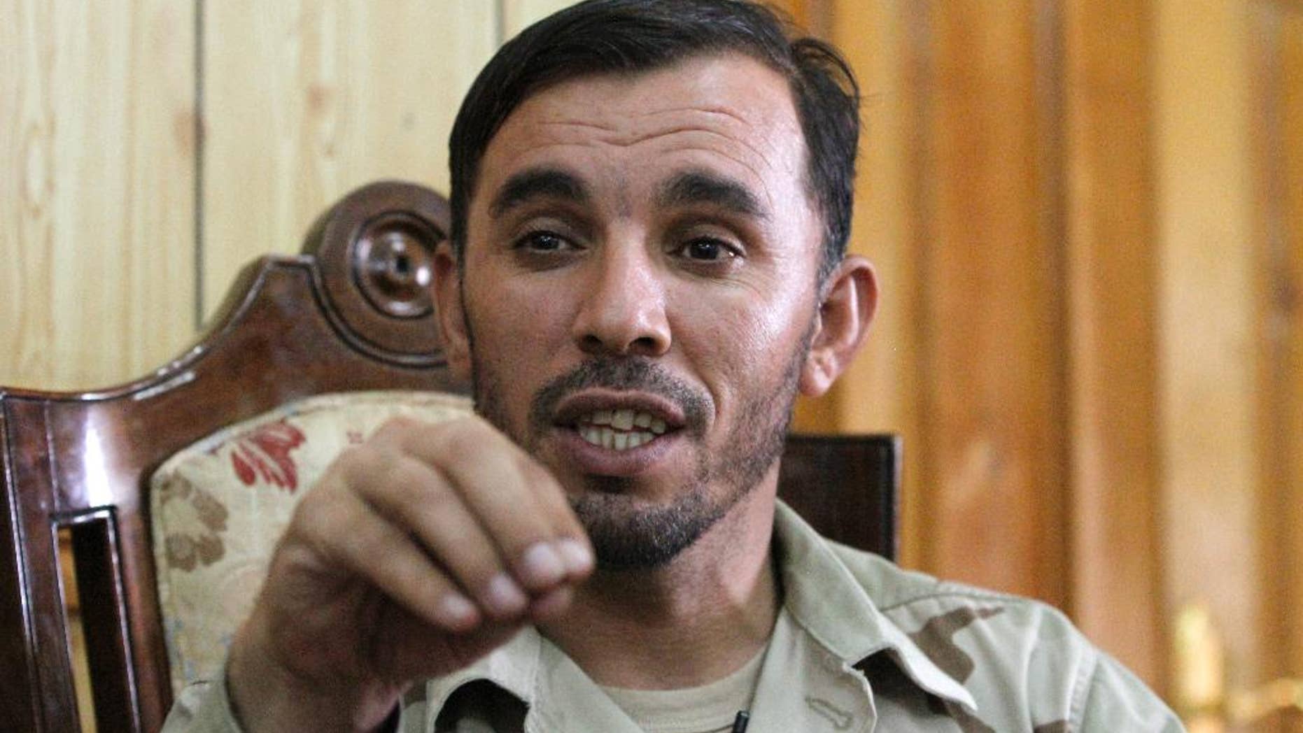 In this Thursday, Aug. 4, 2016 photo, Gen. Abdul Raziq, Kandahar police chief, speaks during an interview with The Associated Press in Kandahar, Afghanistan. Raziq, regarded as one of the country's most powerful men has banned the use of the Pakistani currency in the key southern province of Kandahar. Raziq’s ban came into effect last week. Traders said it had an immediate effect, with the afghani strengthening in recent days. (AP Photos/Allauddin Khan)