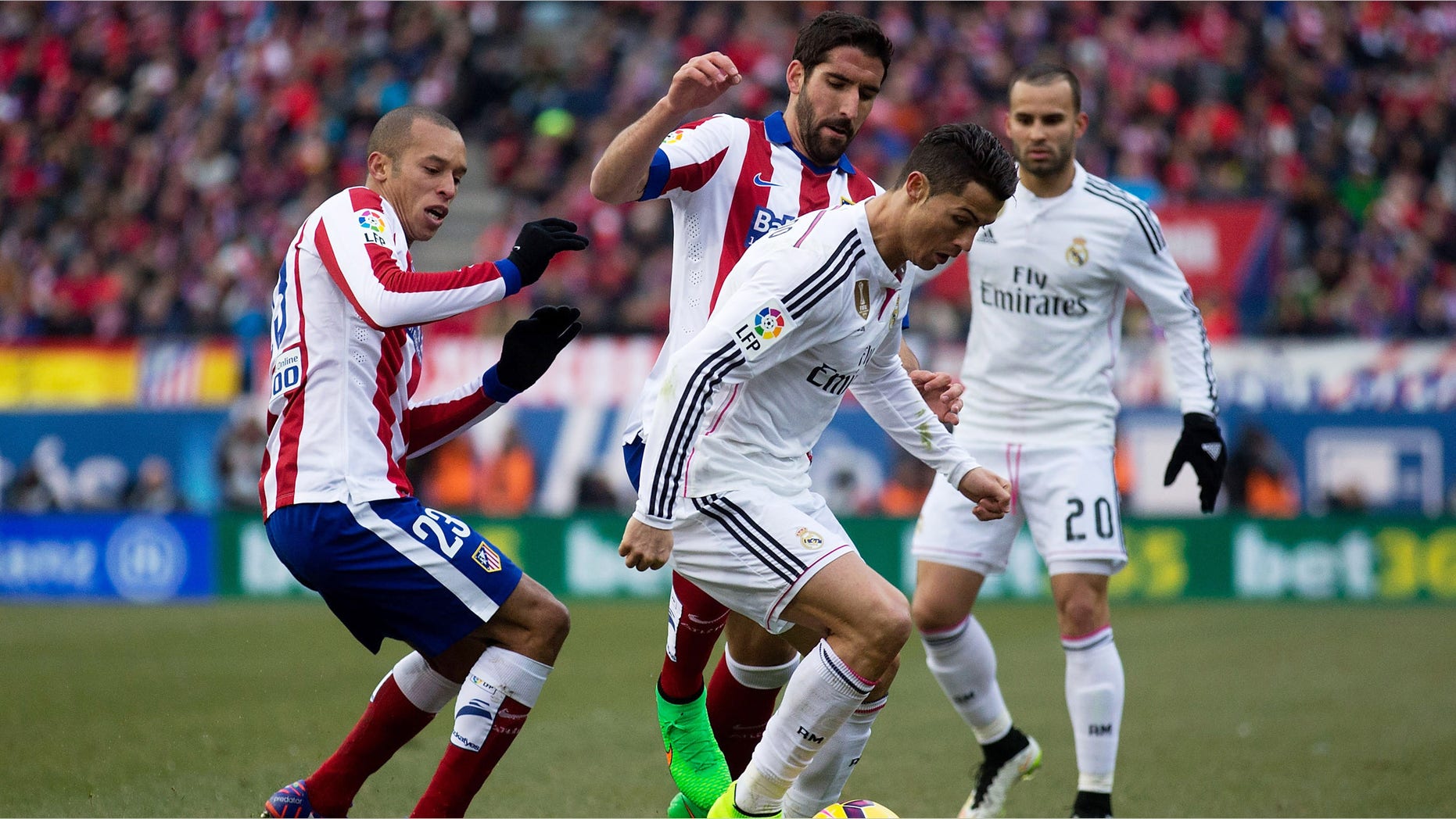 MADRID, SPAIN - FEBRUARY 07: Cristiano Ronaldo (R) of Real Madrid CF competes for the ball with Raul Garcia (2ndL) of Atletico de Madrid and his teammate Joao Miranda (L) during the La Liga match between Club Atletico de Madrid and Real Madrid CF at Vicente Calderon Stadium on February 7, 2015 in Madrid, Spain. (Photo by Gonzalo Arroyo Moreno/Getty Images)