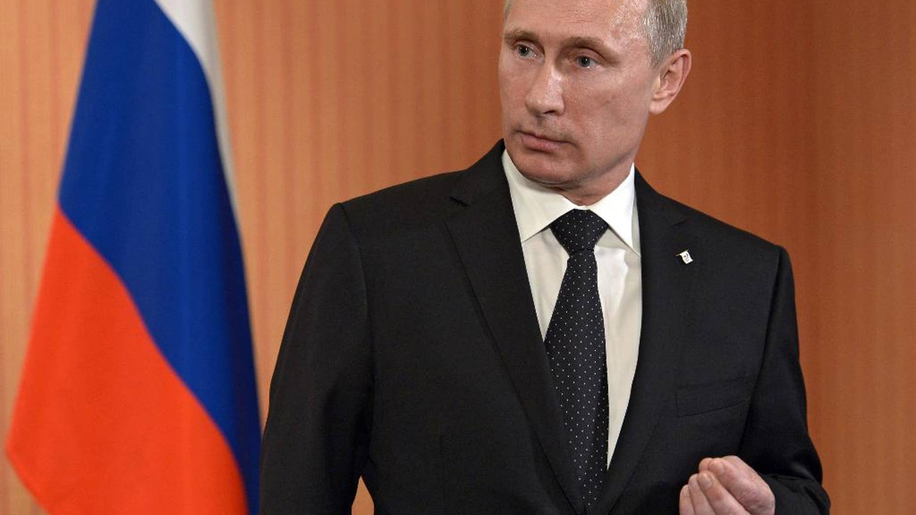 Russian President Vladimir Putin speaks to the media at Benouville castle, Friday, June 6, 2014, where he arrived for the 70th anniversary of the D-Day landings. World leaders and veterans gathered by the beaches of Normandy on Friday to mark the 70th anniversary of World War Two's D-Day landings. (AP Photo/RIA Novosti, Alexei Nikolsky, Presidential Press Service)