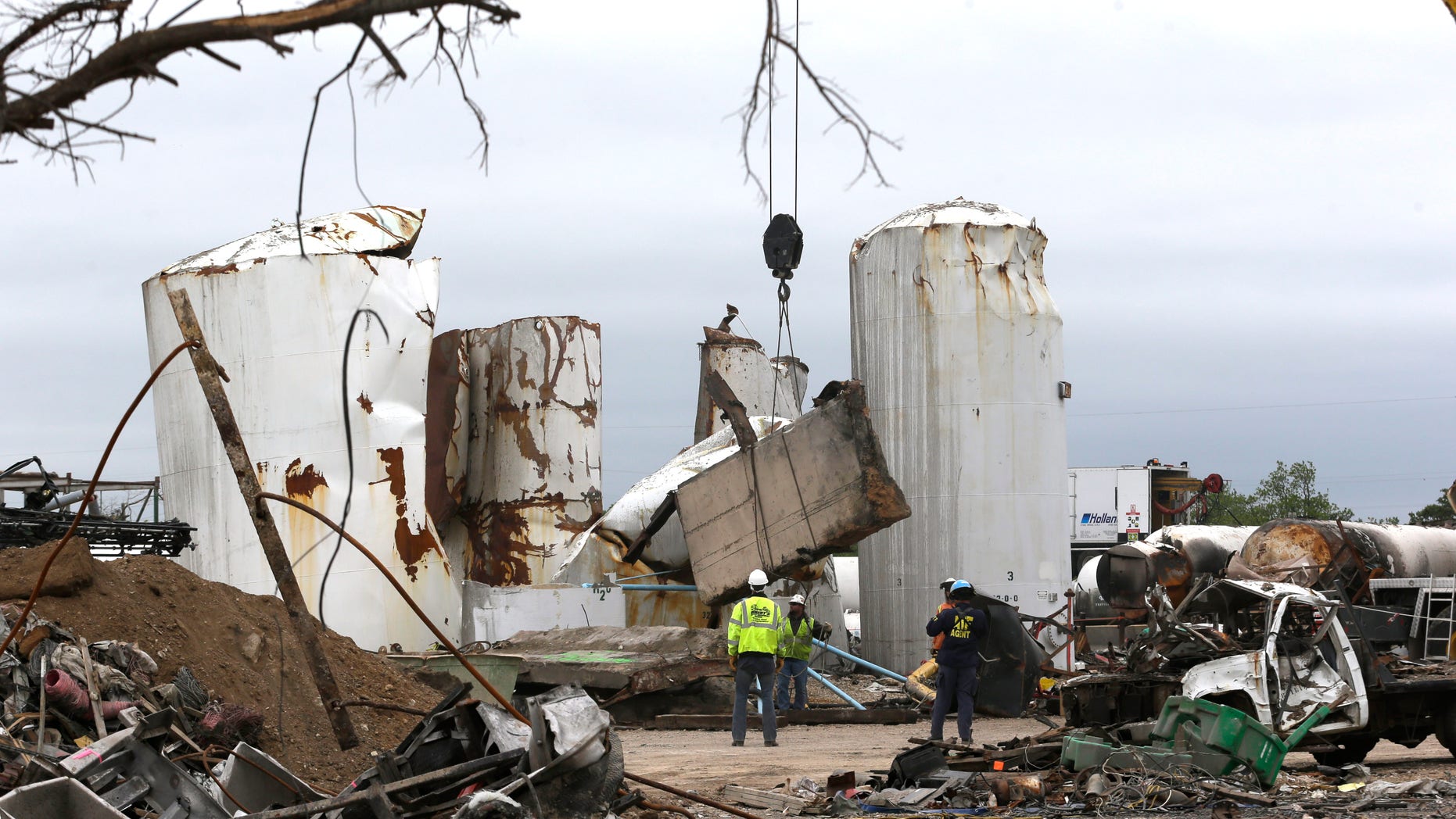 FILE - In this May 2, 2013, file photo investigators move and look through the debris of the destroyed fertilizer plant in West, Texas. Texas law enforcement officials launched a criminal investigation Friday, May 10, 2013, into the massive explosion last month that killed 14 people. (AP Photo/LM Otero, Pool)