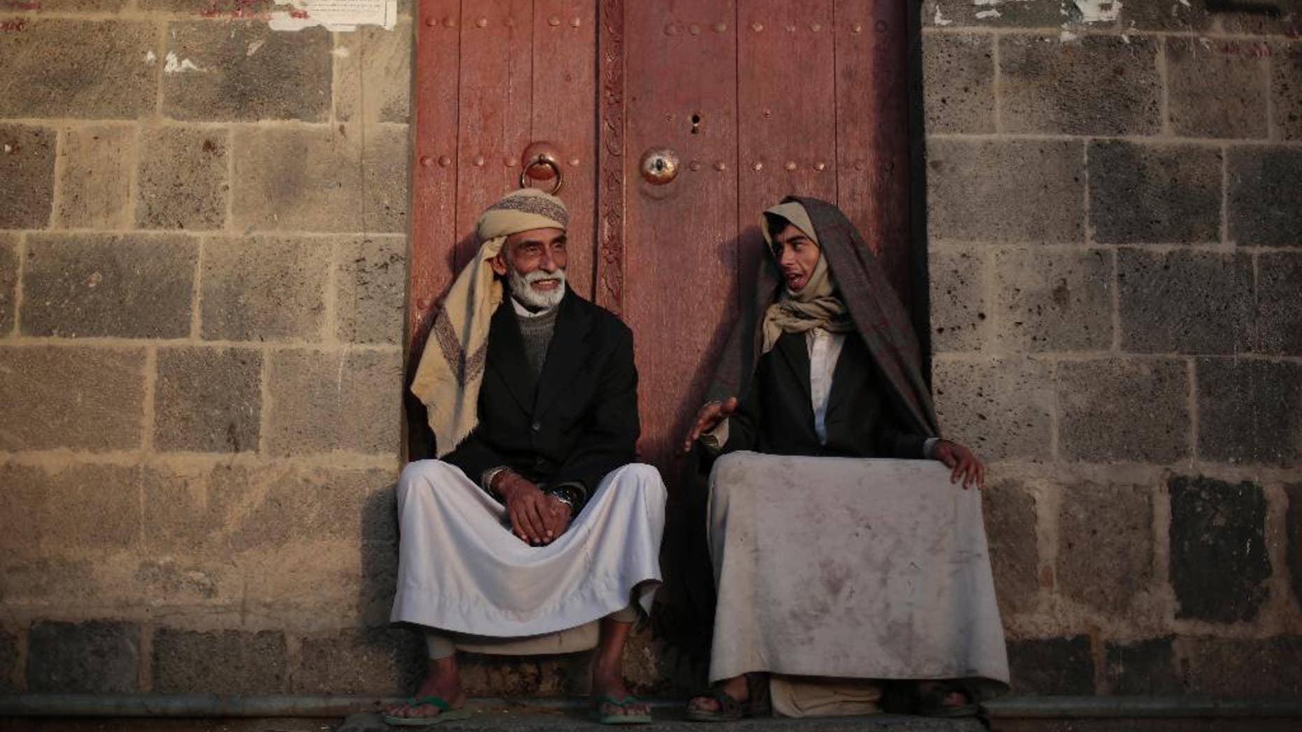Yemeni men chat while sitting in front of their house in the old city of Sanaa, Yemen, Saturday, Nov. 19, 2016. (AP Photo/Hani Mohammed)