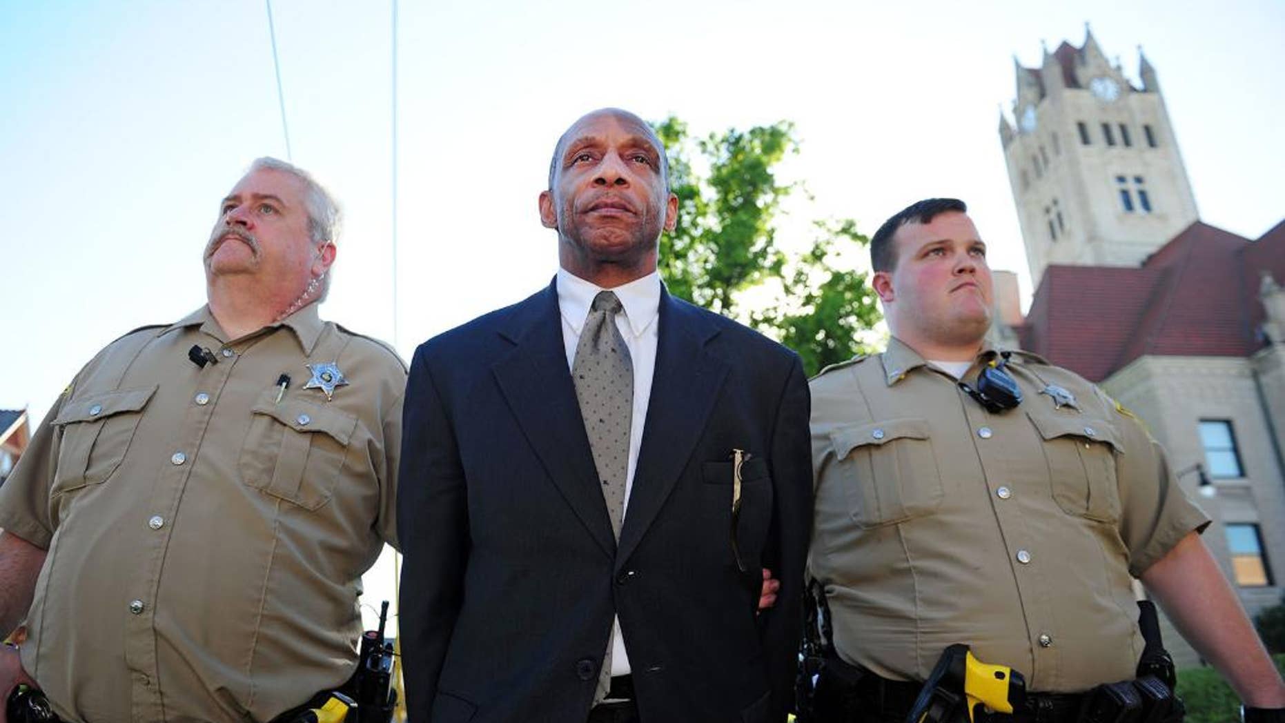 FILE- In this June 22, 2016, file photo, jail officers Mike Evans, left, and Andrew Pfaff escort Charles Goodman back to the Hancock County Jail for holding after a jury found him guilty of two traffic charges in Greenfield, Ind. Goodman, a church bus driver who allegedly used cocaine before a crash near Indianapolis that killed a 6-year-old boy and injured 11 other people, was sentenced to three years in prison Wednesday, July 20. (Tom Russo/Greenfield Daily Reporter via AP, File)