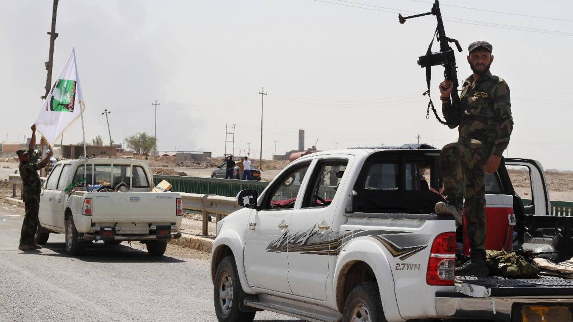 Shiite militiamen patrol in Amirli, 105 miles (170 kilometers) north of Baghdad, Iraq, Sunday, Aug. 31, 2014. Iraqi security forces and Shiite militiamen on Sunday broke a six-week siege imposed by the Islamic State extremist group on the northern Shiite Turkmen town of Amirli, following U.S. airstrikes against the Sunni militants' positions, officials said. (AP Photo)
