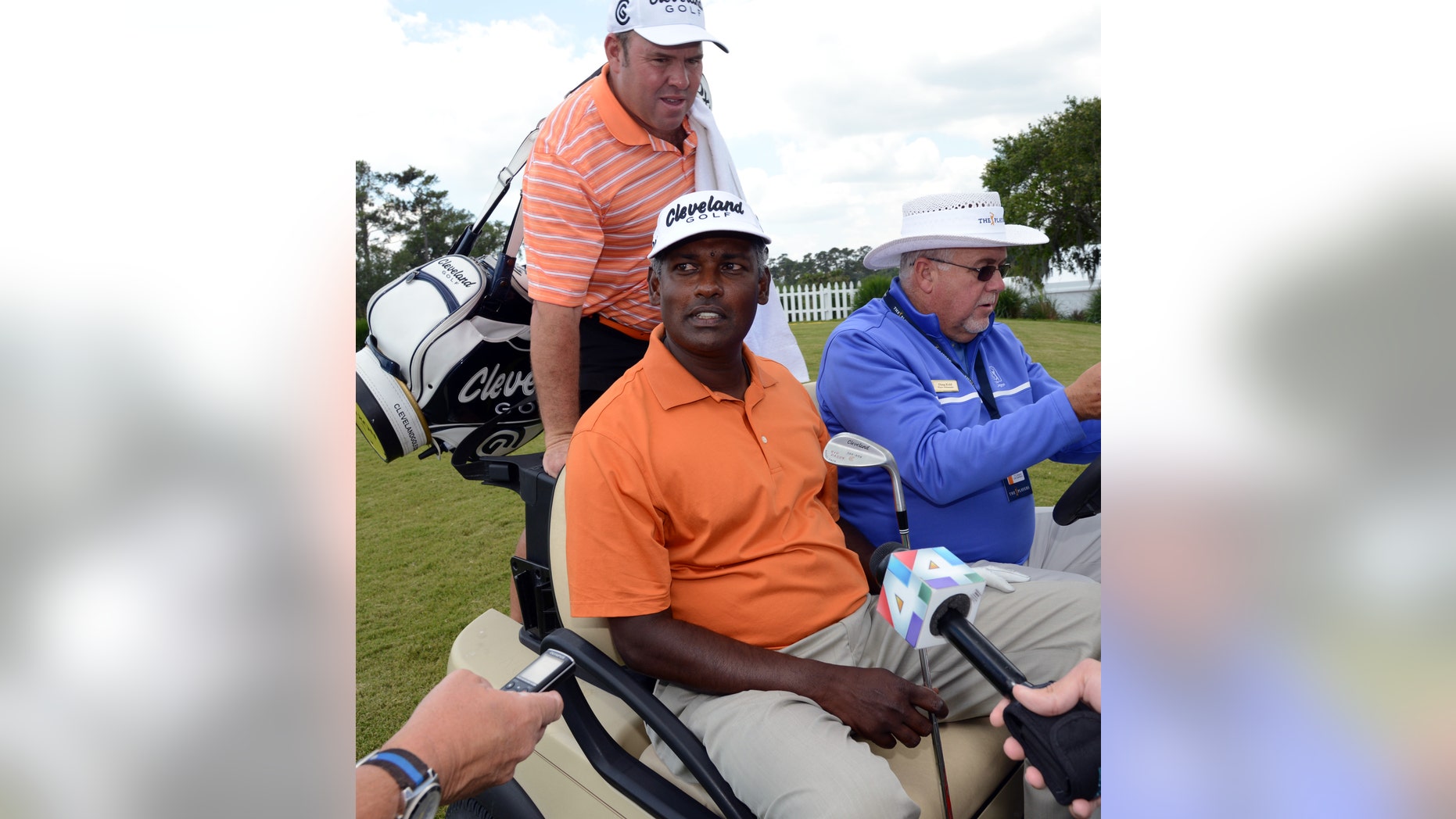 Vijay Singh sits in a cart driven by Doug Kidd, of TPC Sawgass Golf Operations after his practice round at The Players Championship golf tournament Wednesday, May 8, 2013, in Ponte Vedra Beach, Fla. Singh sued the PGA Tour on Wednesday for exposing him to "public humiliation and ridicule" during a 12-week investigation into his use of deer antler spray that ended last week when the tour dropped its case against him. (AP Photo/The Florida Times-Union, Bob Mack)
