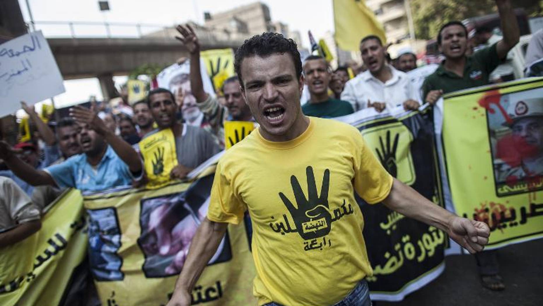 Members of the Muslim Brotherhood and supporters of ousted President Mohamed Morsi march through Cairo on September 6, 2013, wearing the hand logo recently adopted by the group