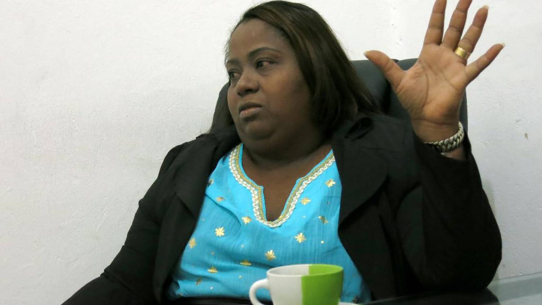 In this Tuesday, June 29, 2016 photo, Jacqueline Montero explains the draft bills she's planning to place to protect sex workers' rights, at her office in Santo Domingo, Dominican Republic. Montero is the first former sex worker who won a seat at the Dominican lower chamber and she will take office next August 16th. (AP Photo.Ezequiel Lopez)