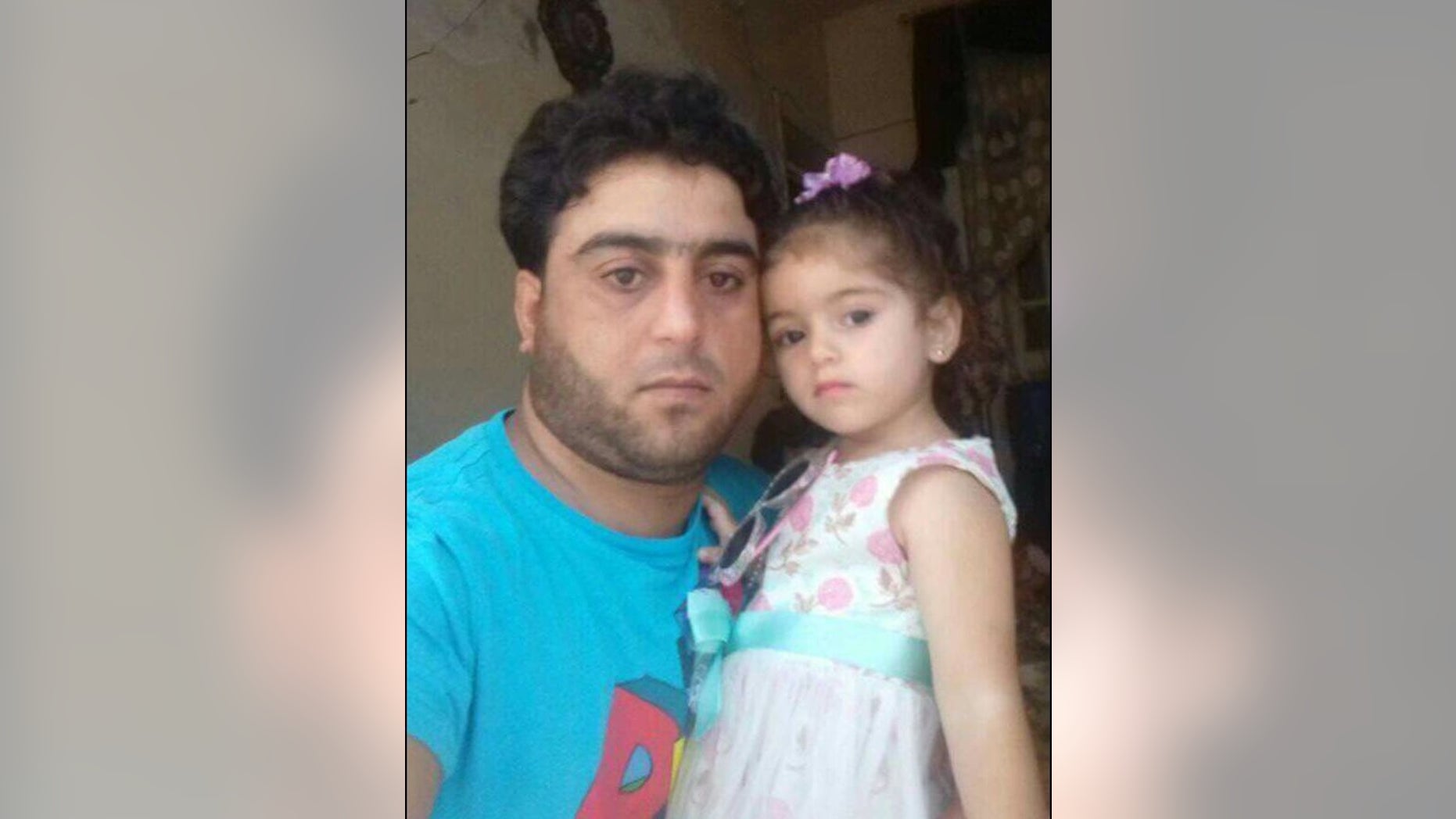 Ghazwan, a Syrian amputee in the rebel-held stronghold of Idlib, pictured with his daughter. He is trying to sell his prosthetic foot to pay back loans and support his family.