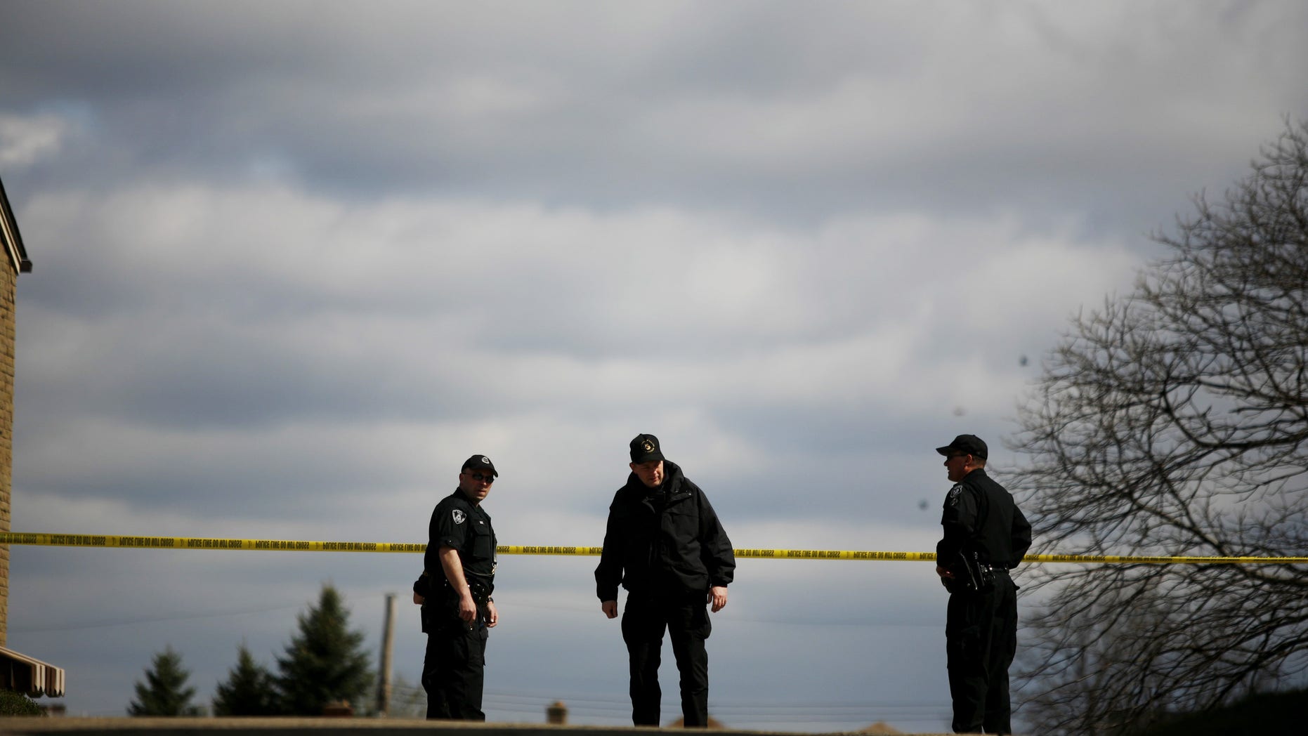 PITTSBURGH - APRIL 4: Pittsburgh Police officers watch over the crime scene from a nearby corner April 4, 2009 in Pittsburgh, Pennsylvania. Five police officers were shot during a standoff with a suspect in the Stanton Heights neighborhood of Pittsburgh, after police responded to a domestic dispute. (Photo by Ross Mantle/Getty Images)