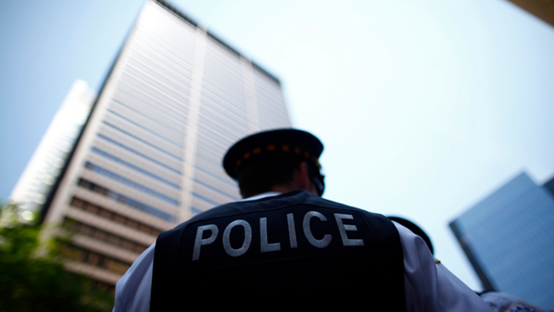 File photo - Police officers watch as protesters rally during a demonstration leading up to the NATO Summit in Chicago May 18, 2012. (REUTERS/Eric Thayer)