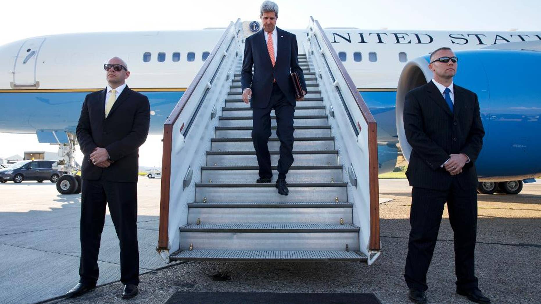 U.S. Secretary of State John Kerry arrives at Stansted Airport outside of London, where he is expected to attend meetings on Syria with the London 11, Wednesday, May 14, 2014. (AP Photo/Jacquelyn Martin, Pool)