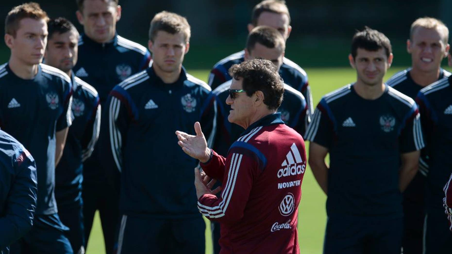 Fabio Capello, Italian coach of Russian national soccer team, center, speaks to his players during a training session in Itu, Brazil, on Thursday, June 19, 2014. Russia will play next game against Belgium in group H of the 2014 soccer World Cup. (AP Photo/Ivan Sekretarev)