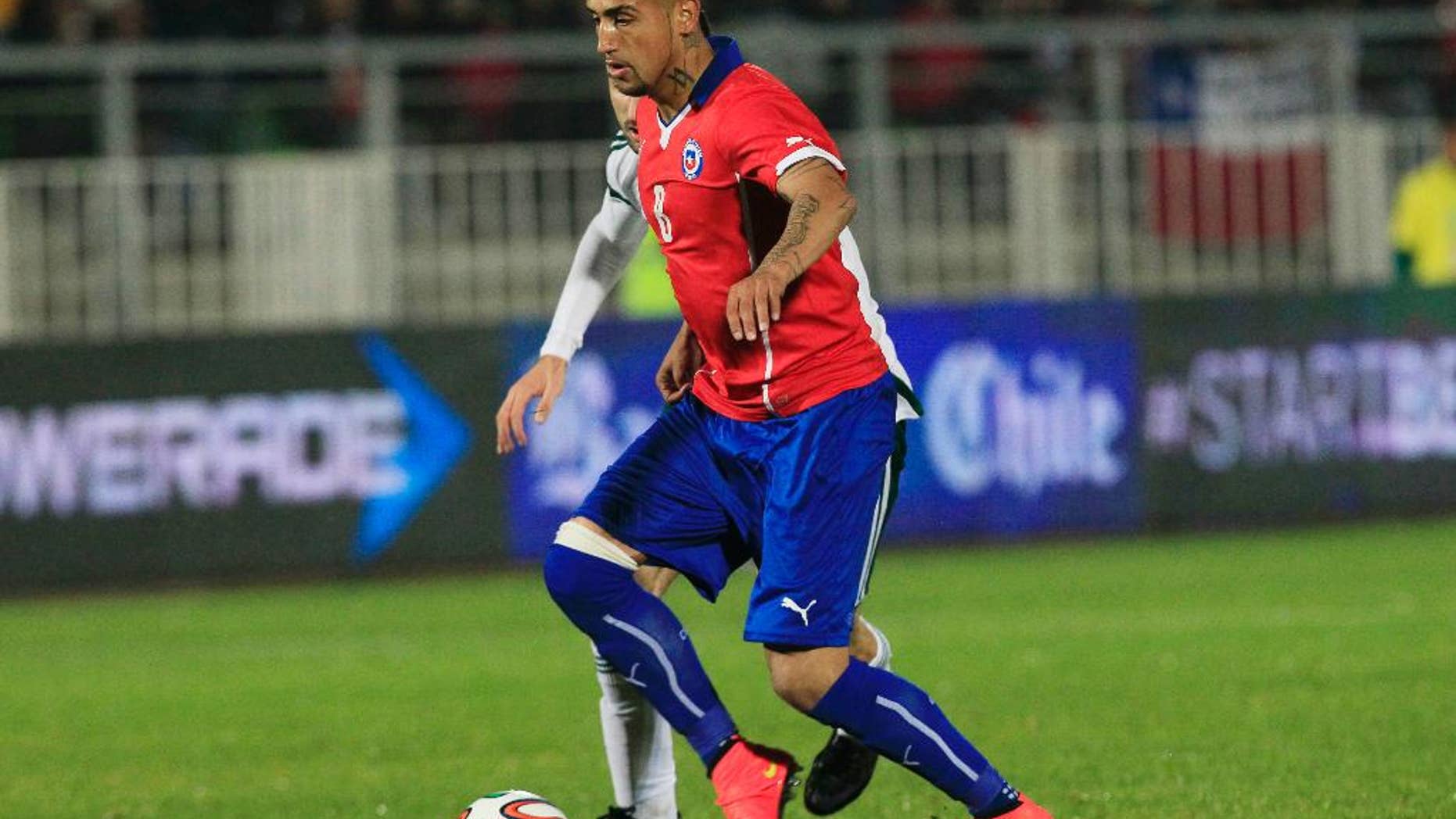 Chile's Jose Rojas, battles for the ball during an international friendly soccer match against Northern Ireland, in Valparaiso, Chile, Wednesday, June 4, 2014. (AP Photo/Luis Hidalgo)