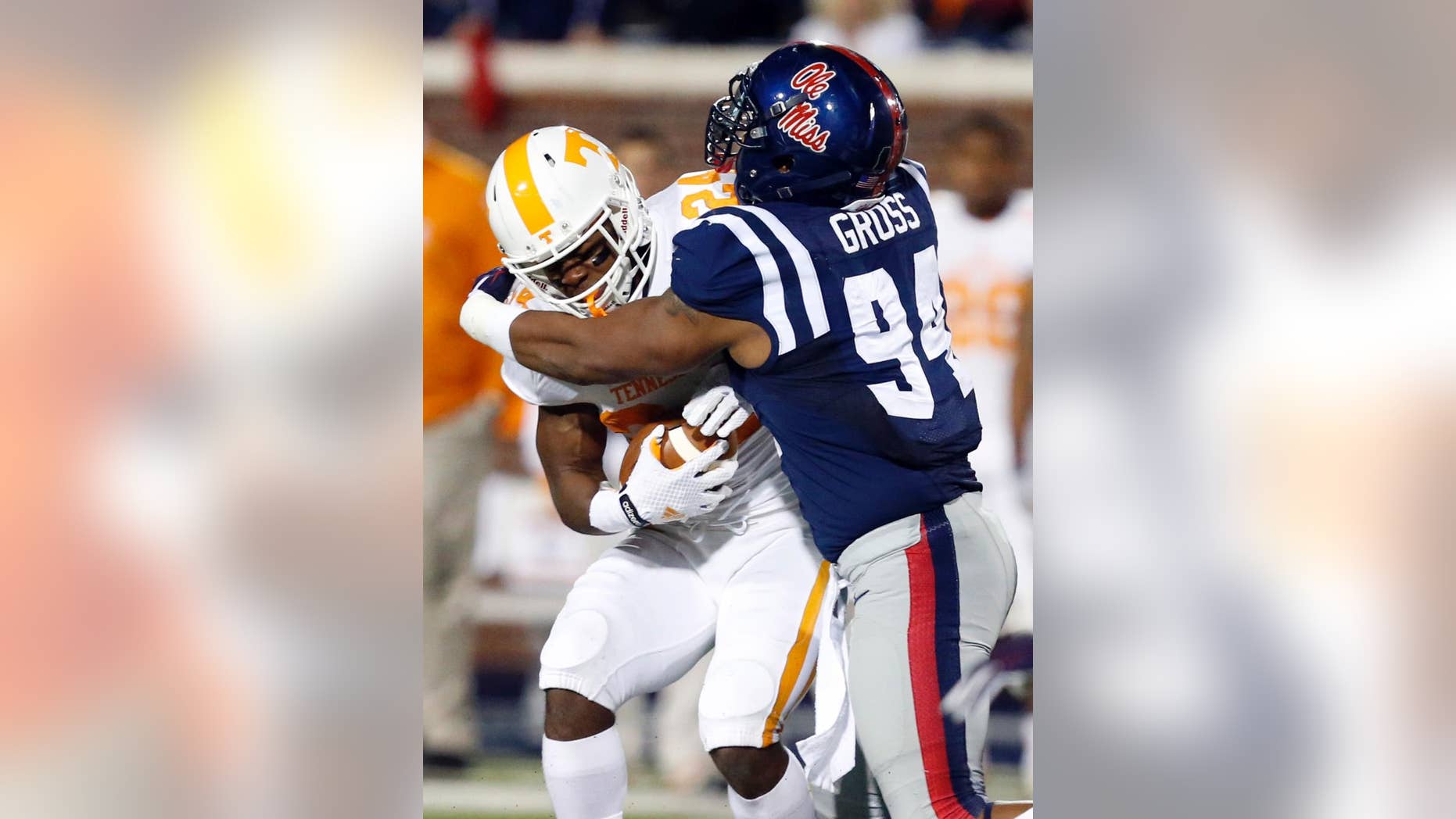 Tennessee running back Derrell Scott (24) is tackled behind the line of scrimmage by Mississippi defensive tackle Issac Gross (94) in the second half of an NCAA college football game in Oxford, Miss., Saturday, Oct. 18, 2014. No. 3 Mississippi won 34-3. (AP Photo/Rogelio V. Solis)