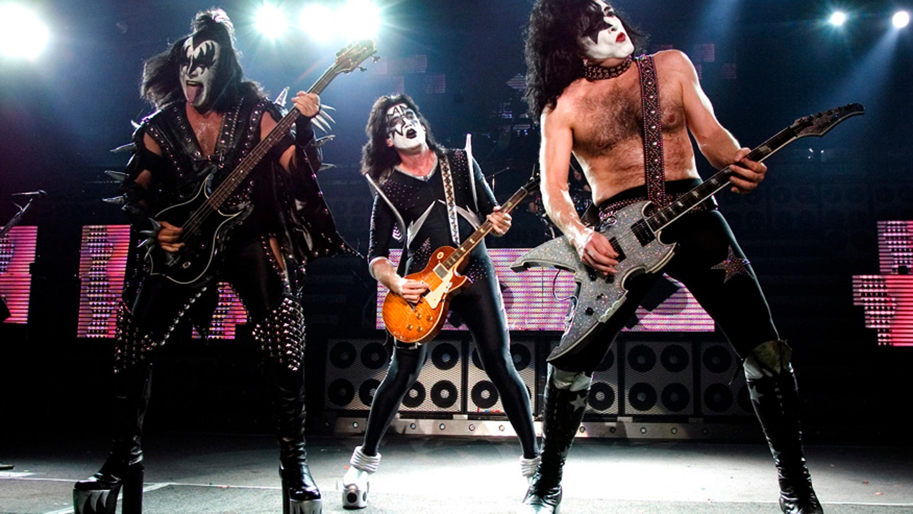 The rock band Kiss, from left, Gene Simmons, Tommy Thayer and Paul Stanley perform during their performance at the PNC Bank Arts Center in Holmdel, N.J. on Tuesday, July 20, 2004.