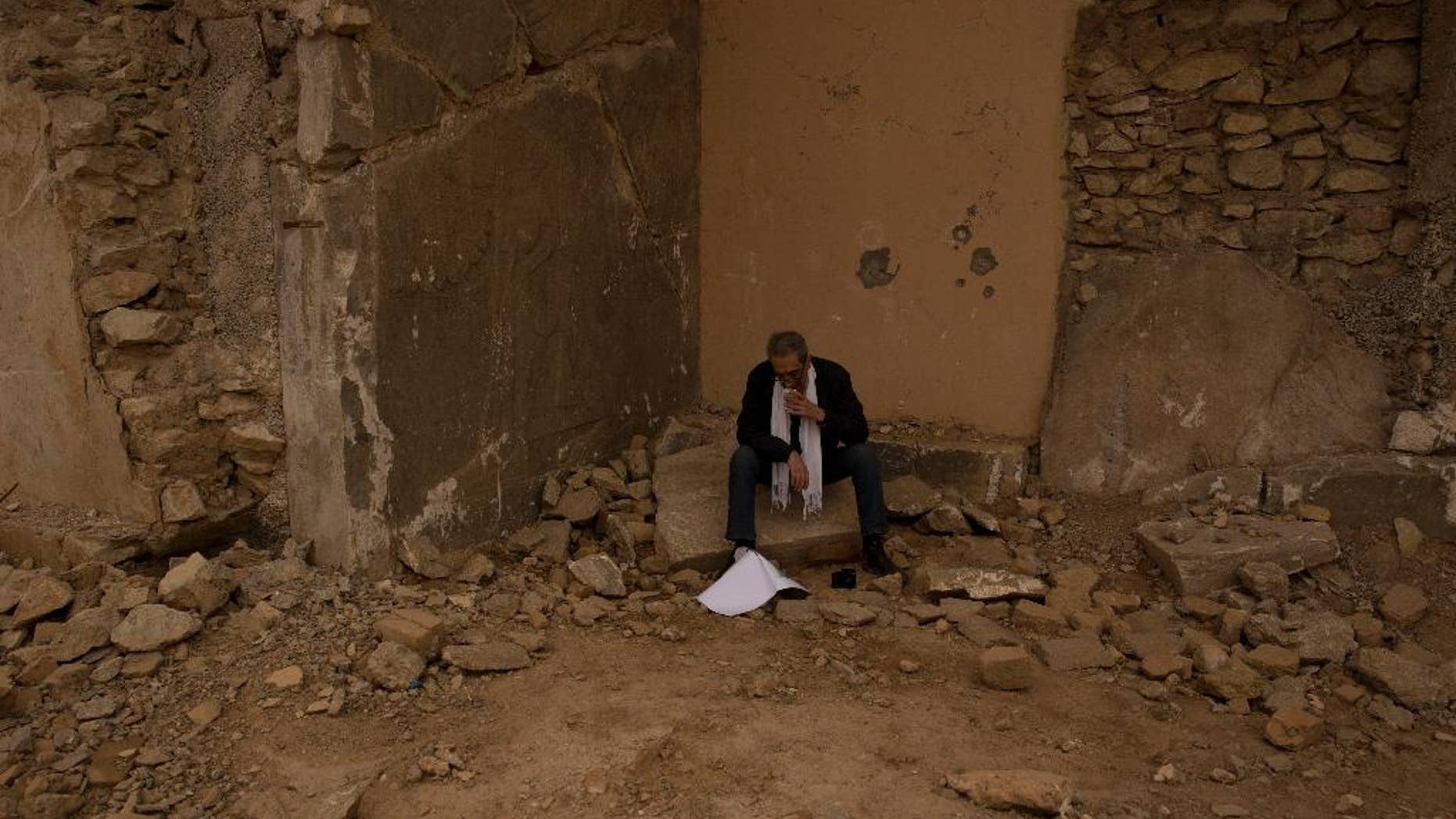 Sami Al-Khoja, management and liaison officer with the United Nations Educational, Scientific and Cultural Organization (UNESCO) pauses after seeing the the ancient site of Nimrud, Iraq, for the first time after it was destroyed by Islamic State militants, on Wednesday, Dec. 14, 2016. (AP Photo/Maya Alleruzzo)
