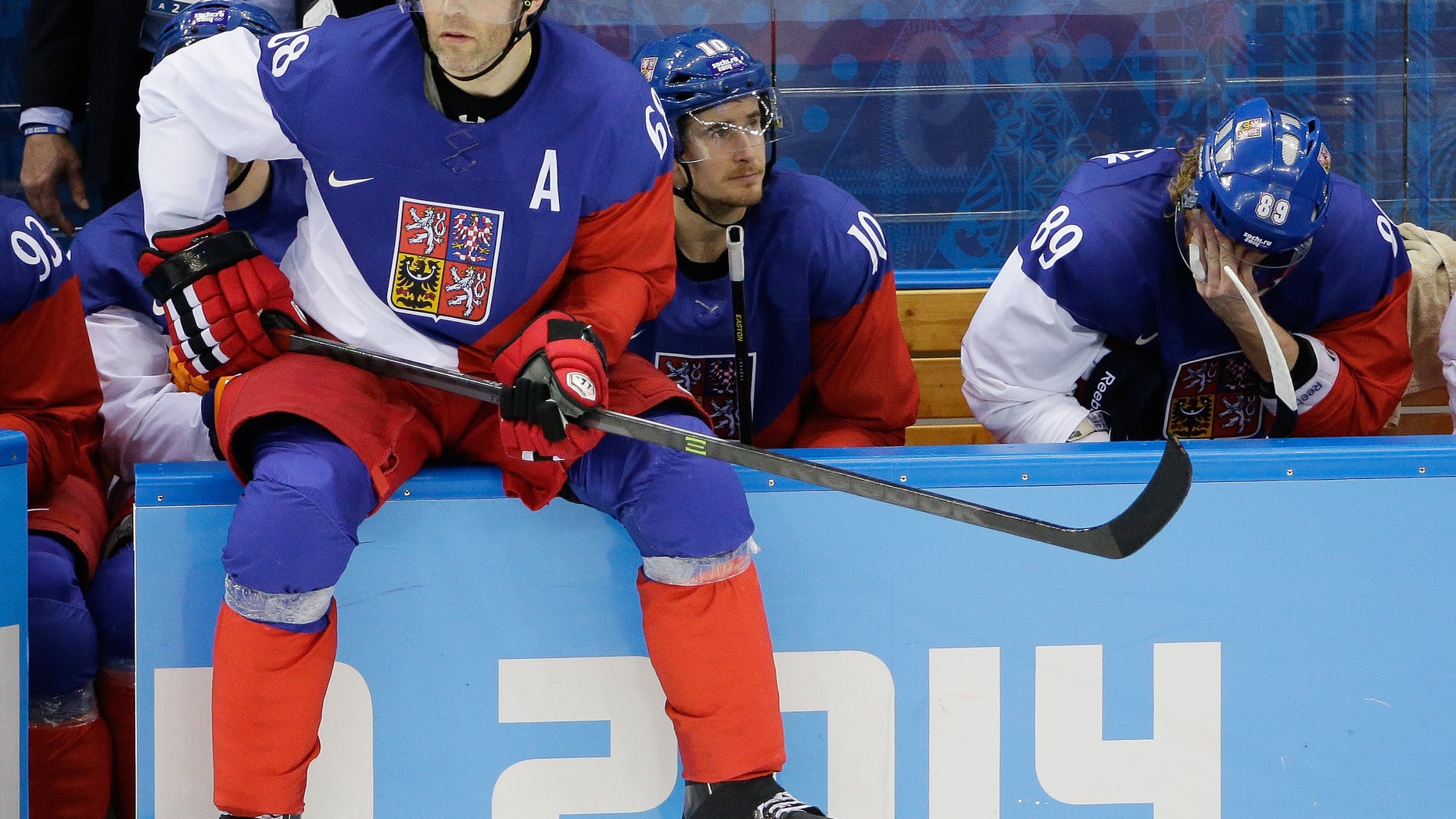 Czech Republic forward Jaromir Jagr sits on the boards waiting to enter the game during the third period of men's quarterfinal hockey game against the United States in Shayba Arena at the 2014 Winter Olympics, Wednesday, Feb. 19, 2014, in Sochi, Russia. (AP Photo/David J. Phillip )
