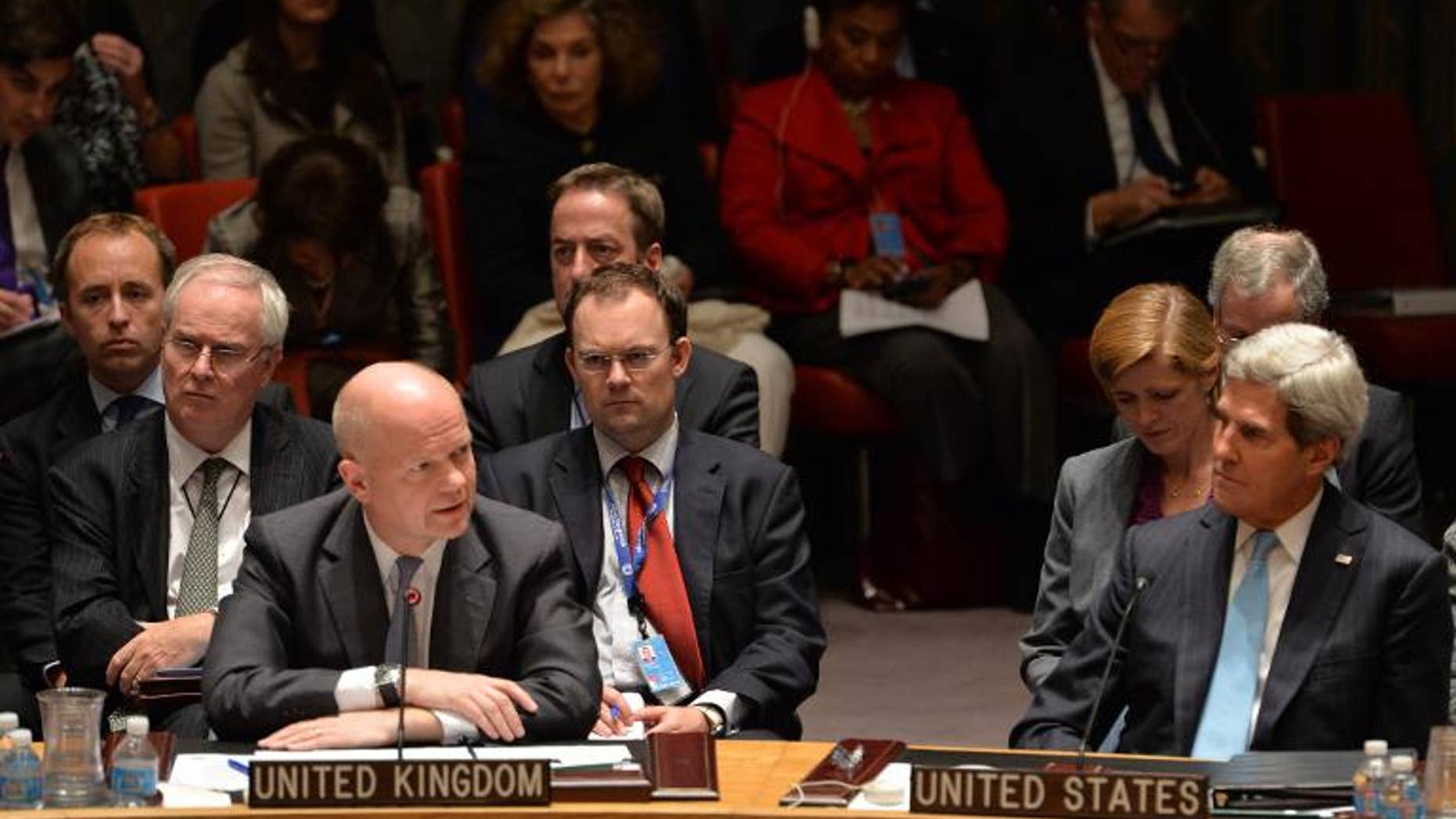 British Foreign Minister William Hague (L) speaks in the UN Security Council just after it voted to approve a resolution that will require Syria to give up its chemical weapons, on September 27, 2013 at the UN headquarters in New York