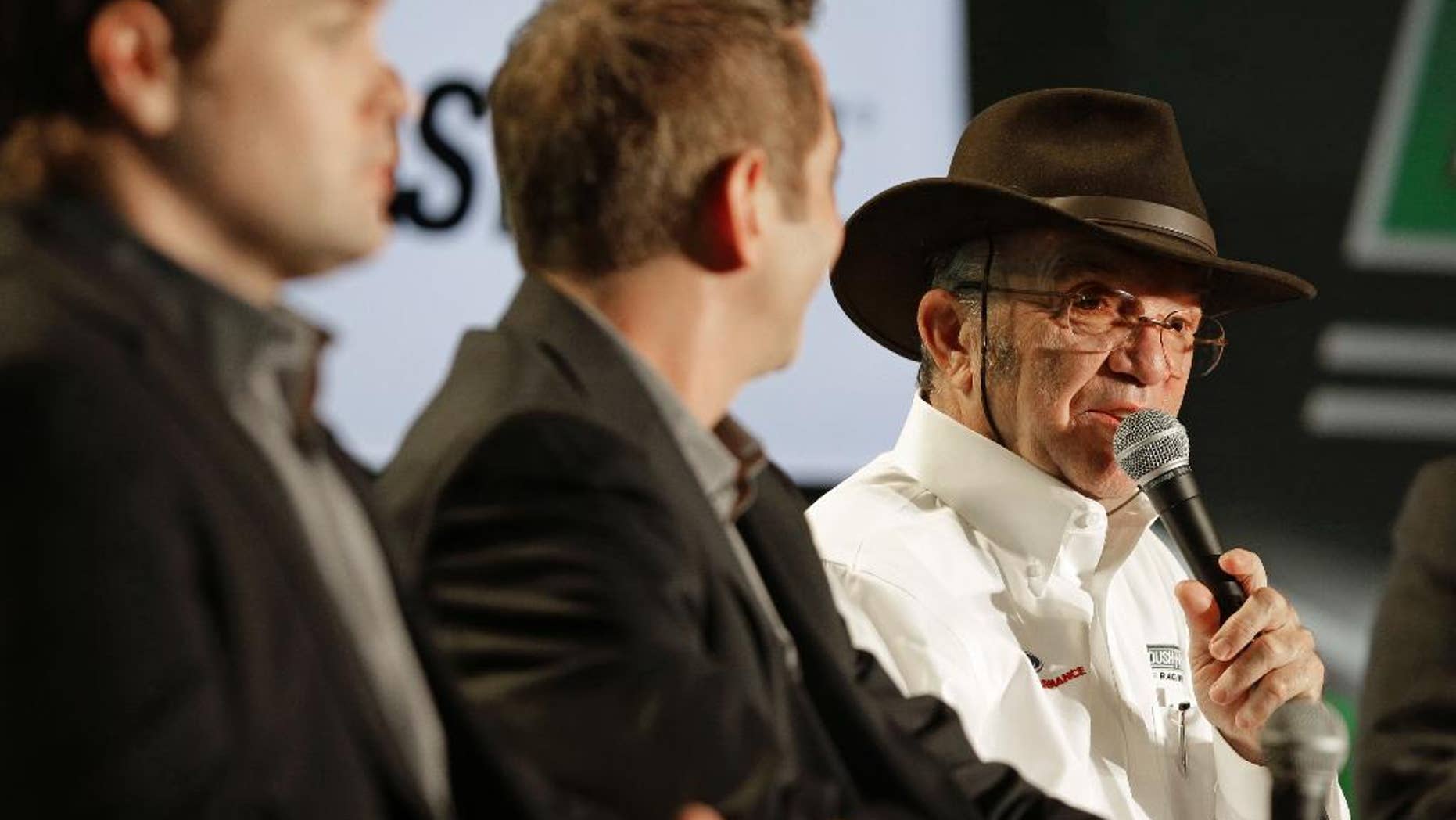 Team owner Jack Roush, right, speaks to the media as drivers Greg Biffle, center, and Ricky Stenhouse Jr, left, listen during the NASCAR Charlotte Motor Speedway media tour in Charlotte, N.C., Wednesday, Jan. 28, 2015. (AP Photo/Chuck Burton)
