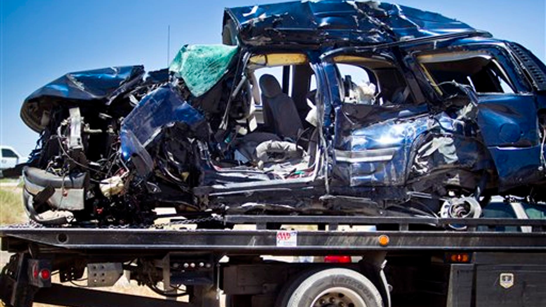 The wreckage of the Border Agents' SUV is removed from the accident scene Thursday, May 12, 2011 in Gila Bend, Ariz. Authorities say a fast-moving freight train that collided with the SUV, killing two Border Patrol agents, tried to get the driver's attention by blowing its horn before the crash. (AP Photo/The Arizona Republic, Carlos Chavez)