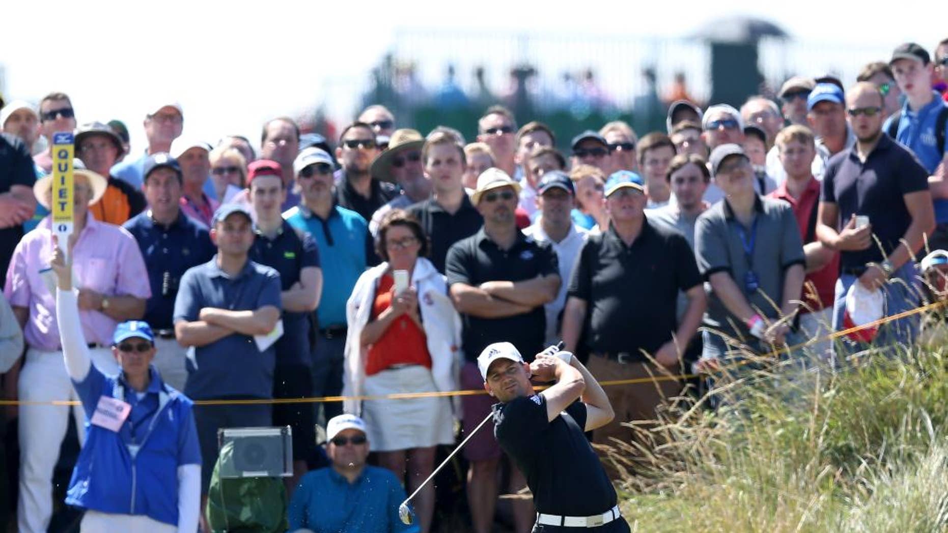 Sergio Garcia of Spain plays a shot off the 14th tee during the first day of the British Open Golf championship at the Royal Liverpool golf club, Hoylake, England, Thursday July 17, 2014. (AP Photo/Scott Heppell)
