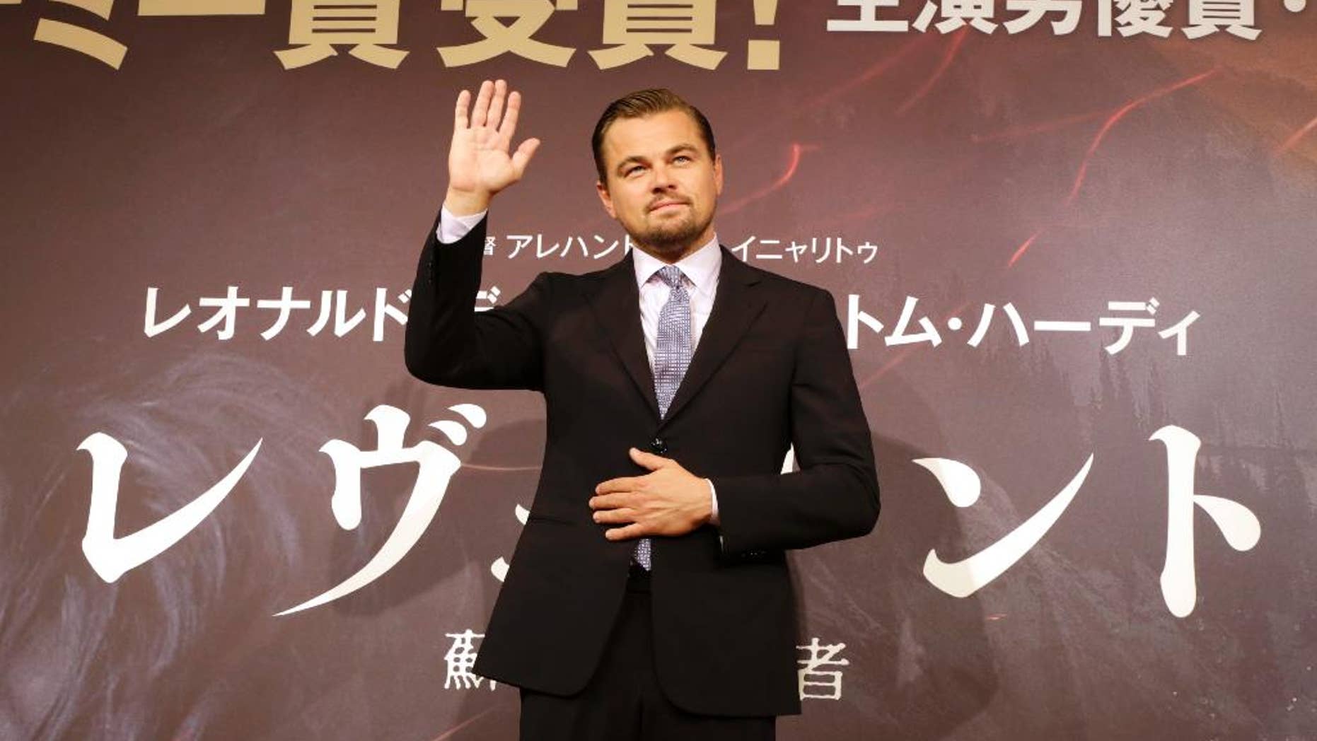 FILE - In this Wednesday, March 23, 2016, Actor Leonardo DiCaprio waves during a photo session of the movie “The Revenant” in Tokyo. An Indonesian immigration official says Hollywood actor Leonardo DiCaprio may be banned from returning to Indonesia over his criticisms that palm oil plantations are destroying the country's rainforests. (AP Photo/Eugene Hoshiko, File)