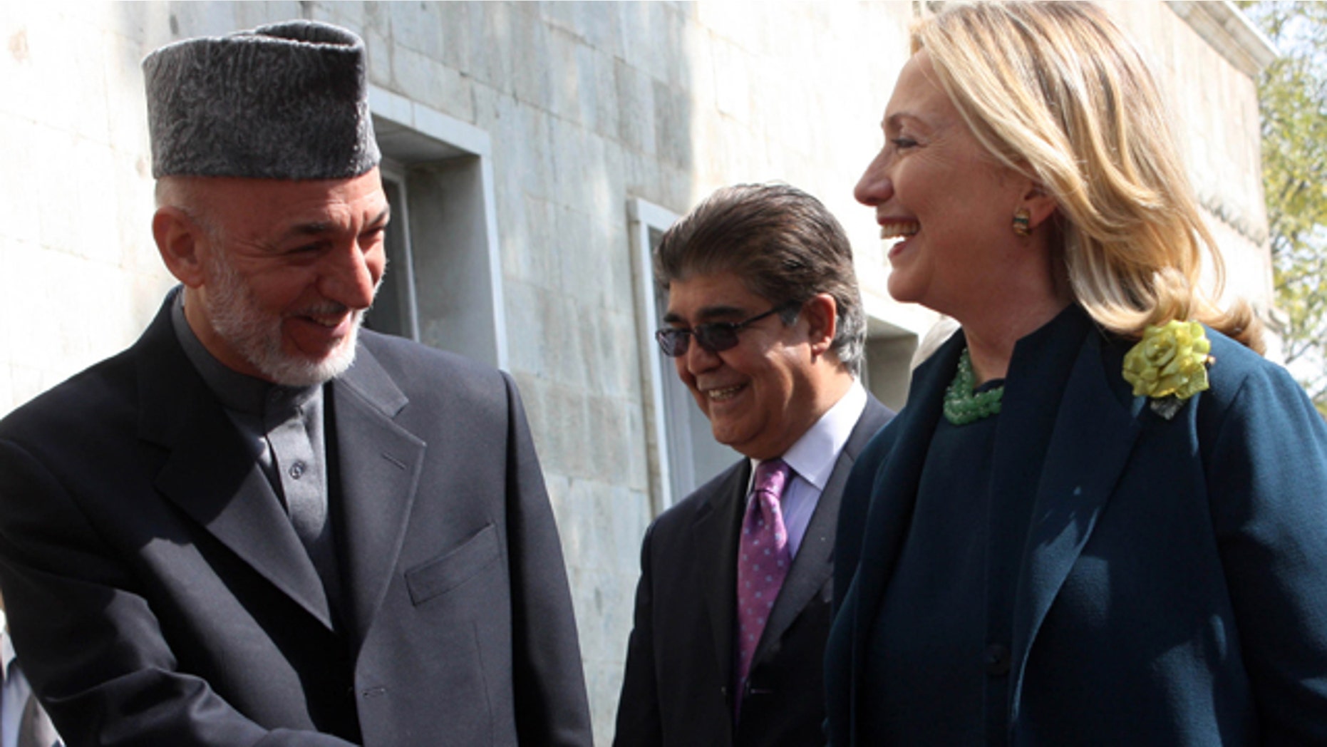 Oct. 20: US Secretary of State Hillary Rodham Clinton, right, shakes hands with Afghanistan's President Hamid Karzai during their meeting in Kabul.