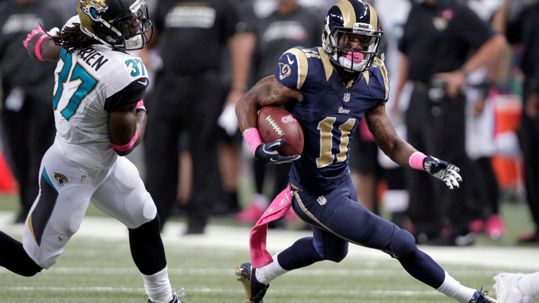 St. Louis Rams wide receiver Tavon Austin, right, runs with the ball past Jacksonville Jaguars safety John Cyprien, left, after catching a pass for a 25-yard gain during the second quarter of an NFL football game Sunday, Oct. 6, 2013, in St. Louis. (AP Photo/Tom Gannam)