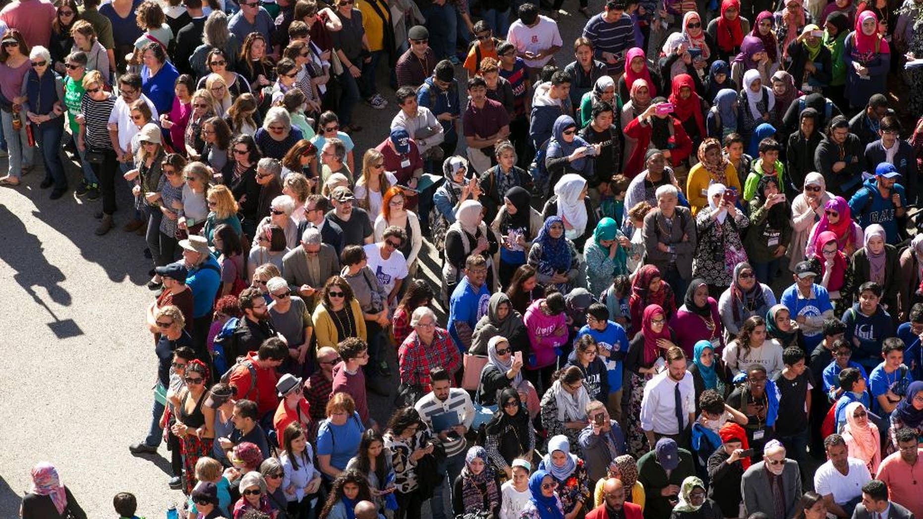 Thousands of supporters protect hundreds of Muslims attending Muslim Day at the Capitol form a human chain in Austin, Texas, on Tuesday Jan. 31, 2017. Texas Gov. Greg Abbott made no mention of President Donald Trump' temporary ban on immigrants from seven Muslim-majority nations during his State of the State address that was going on inside the Capitol. (Jay Janner/Austin American-Statesman via AP)