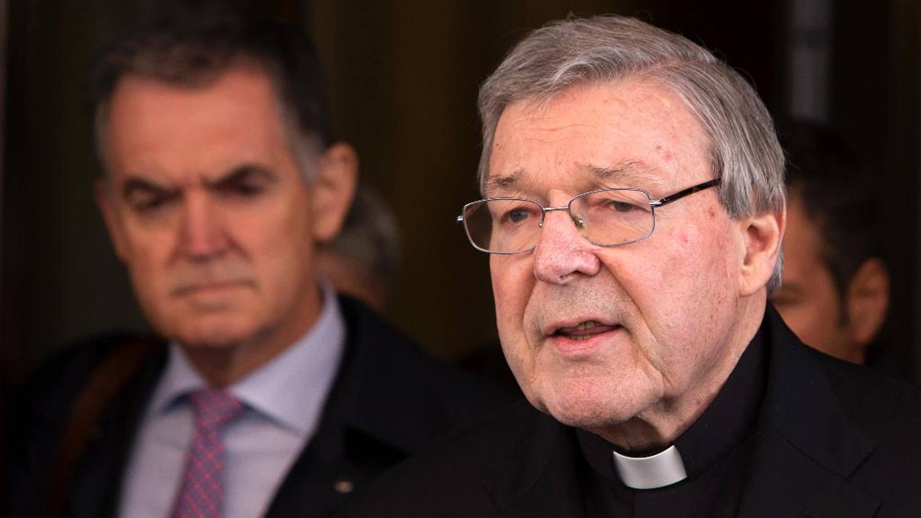 FILE - In this March 3, 2016 file photo, Australian cardinal George Pell reads a statement to reporters as he leaves the Quirinale hotel after meeting members of the Australian group of relatives and victims of priestly sex abuses, in Rome, Italy. Australian police flew to Rome to interview a top Vatican cardinal about allegations of sexual assault dating back decades, officials said Wednesday, Oct. 26, 2016. Cardinal George Pell, Pope Francis' top financial adviser, has long been dogged by allegations of mishandling cases of clergy abuse when he was archbishop of Melbourne and later Sydney.(AP Photo/Riccardo De Luca, File)
