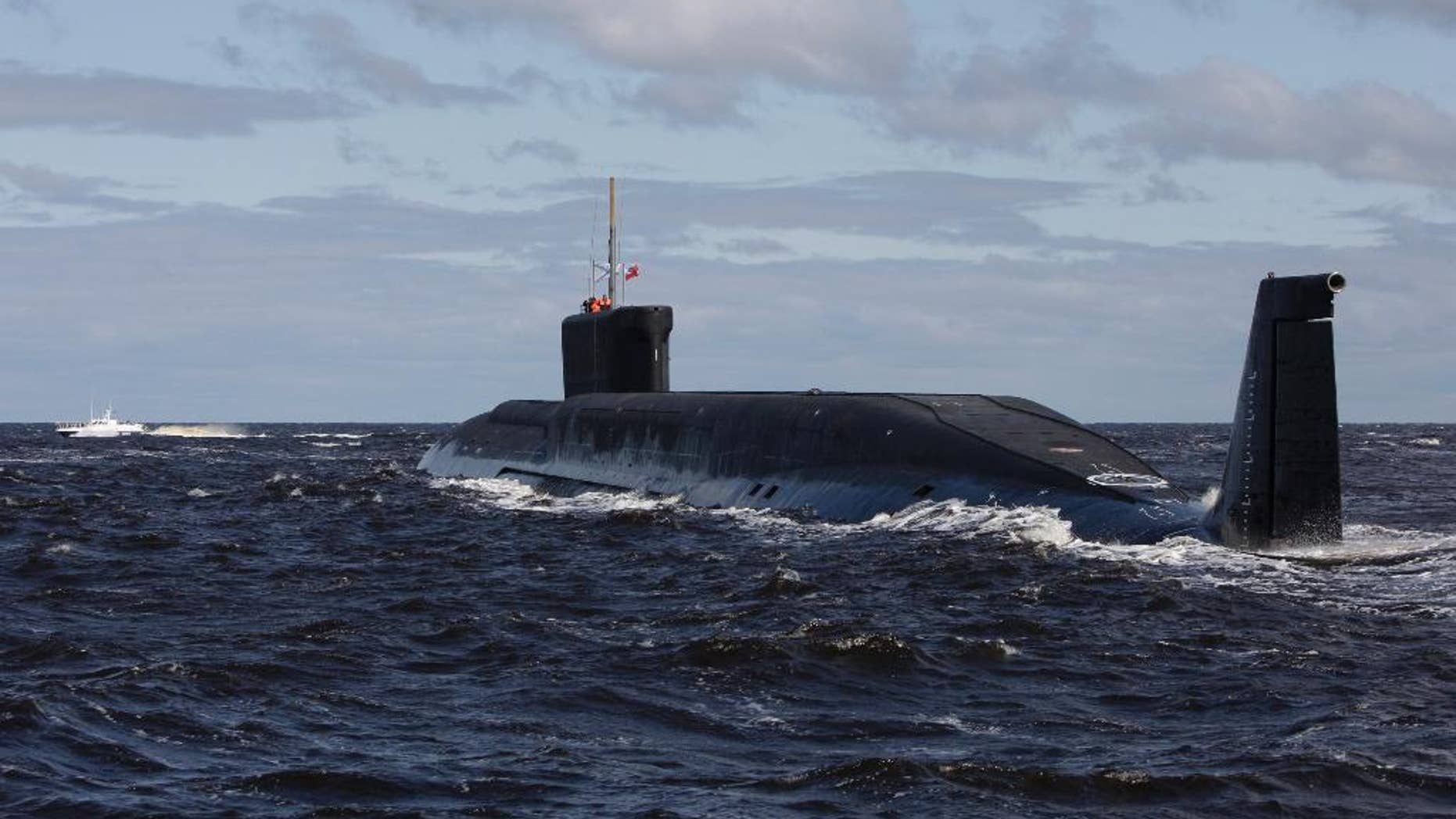 FILE - in this file photo taken on Thursday, July 2, 2009, the Russian nuclear submarine, Yuri Dolgoruky, is seen during sea trials near Arkhangelsk, Russia. The Russian navy said in a statement Friday March 31, 2017, that its submarines have increased combat patrols to the level last seen during the Cold War. (AP Photo/Alexander Zemlianichenko, File)
