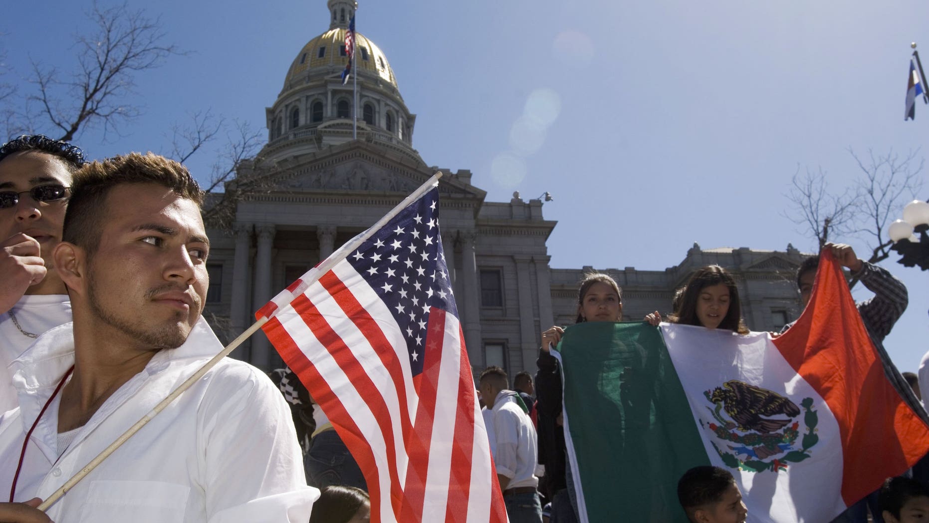 DENVER - APRIL 19: Adrian Campos, 16, holds a U.S. flag during a rally with about 3,000 middle and high school students who walked out of school April 19, 2006 in Denver, Colorado. The students gathered on the steps of the Colorado state Capitol to demonstrate in support of immigrant rights and against U.S. Congressional immigration reform proposals. (Photo by Kevin Moloney/Getty Images)