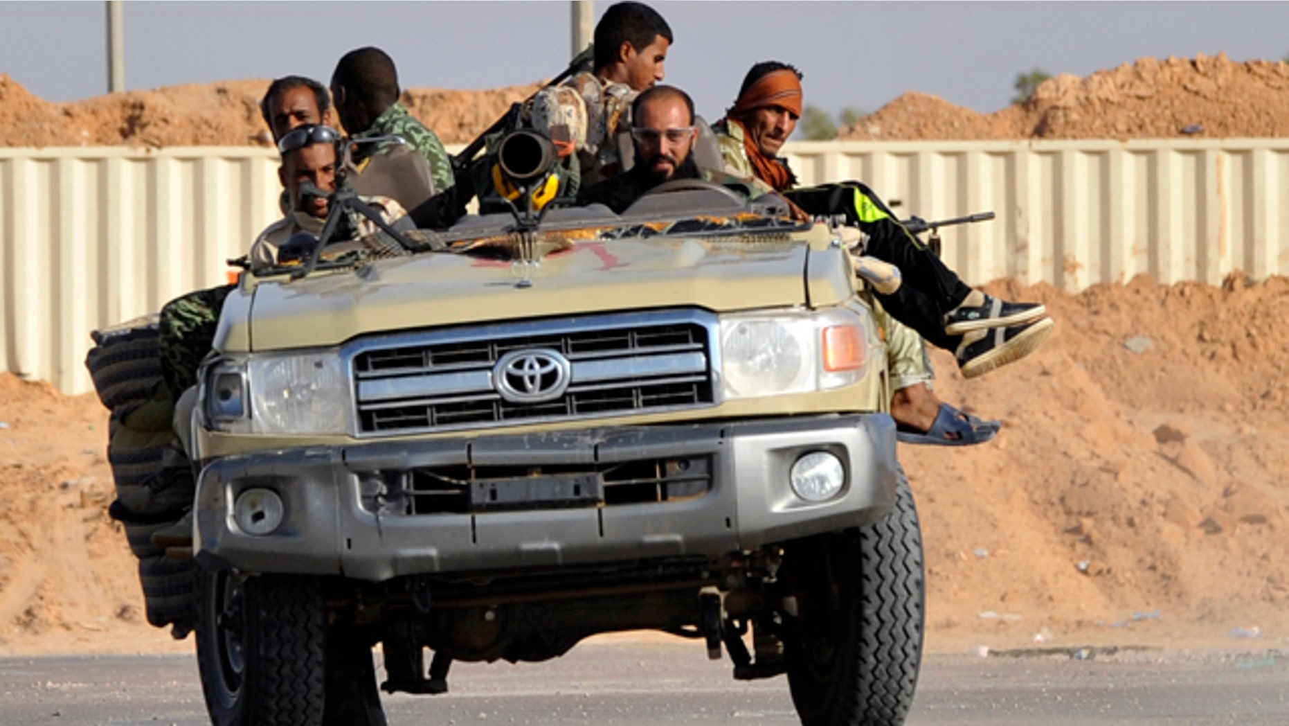 Sept. 27: Libyan revolutionary fighters drive their off-road truck outside Sirte, Libya.