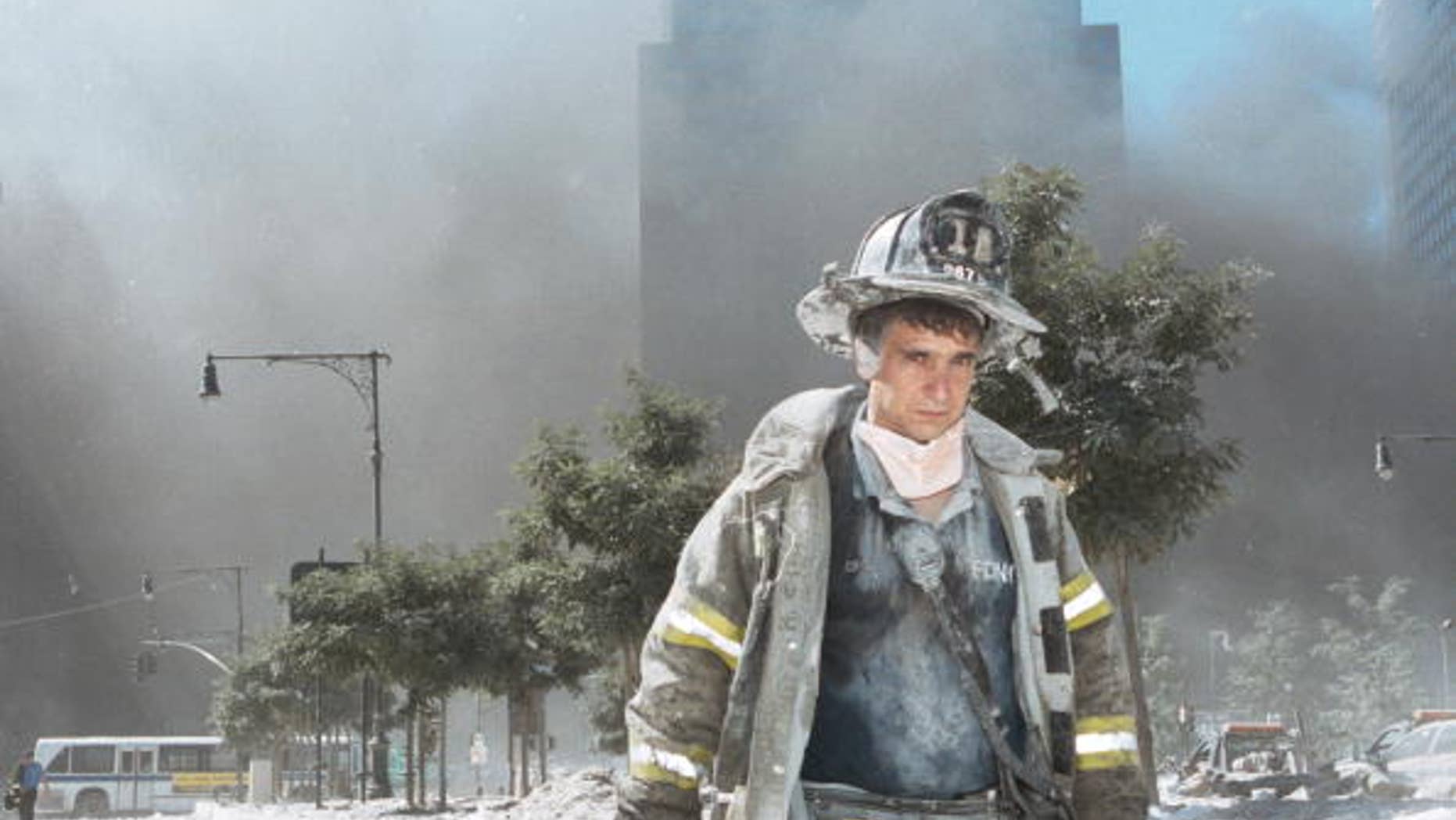 An unidentified New York City firefighter walks away from Ground Zero after the collapse of the Twin Towers September 11, 2001 in New York City.