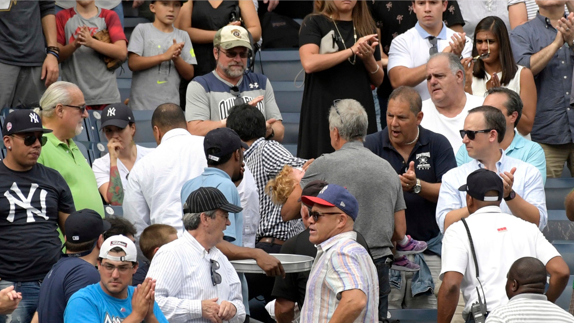 Baseball fans react after a toddler was hit by a foul ball Wednesday at Yankee Stadium.