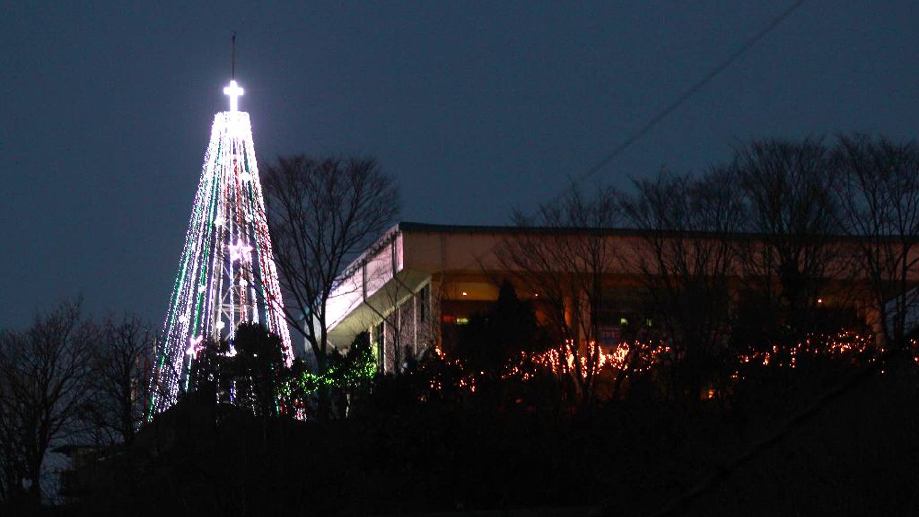 This Tuesday, Dec. 21, 2010 photo shows a giant steel Christmas tree lit up at the western mountain peak known as Aegibong in Gimpo, South Korea. A South Korean church group has canceled plans to erect the giant Christmas tree near the border with North Korea after locals complained that it could provoke Pyongyang. (AP Photo/Lee Jin-man)